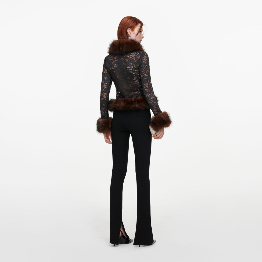 Back view of a woman wearing the Black Flared Knit Trousers