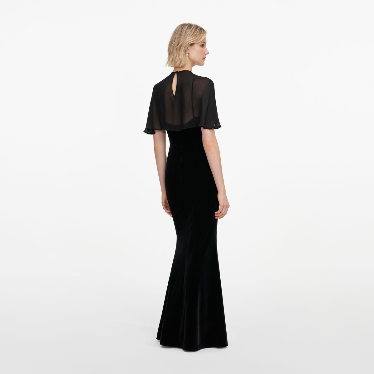 Back view of a woman wearing the Black Velvet Cape Maxi Dress