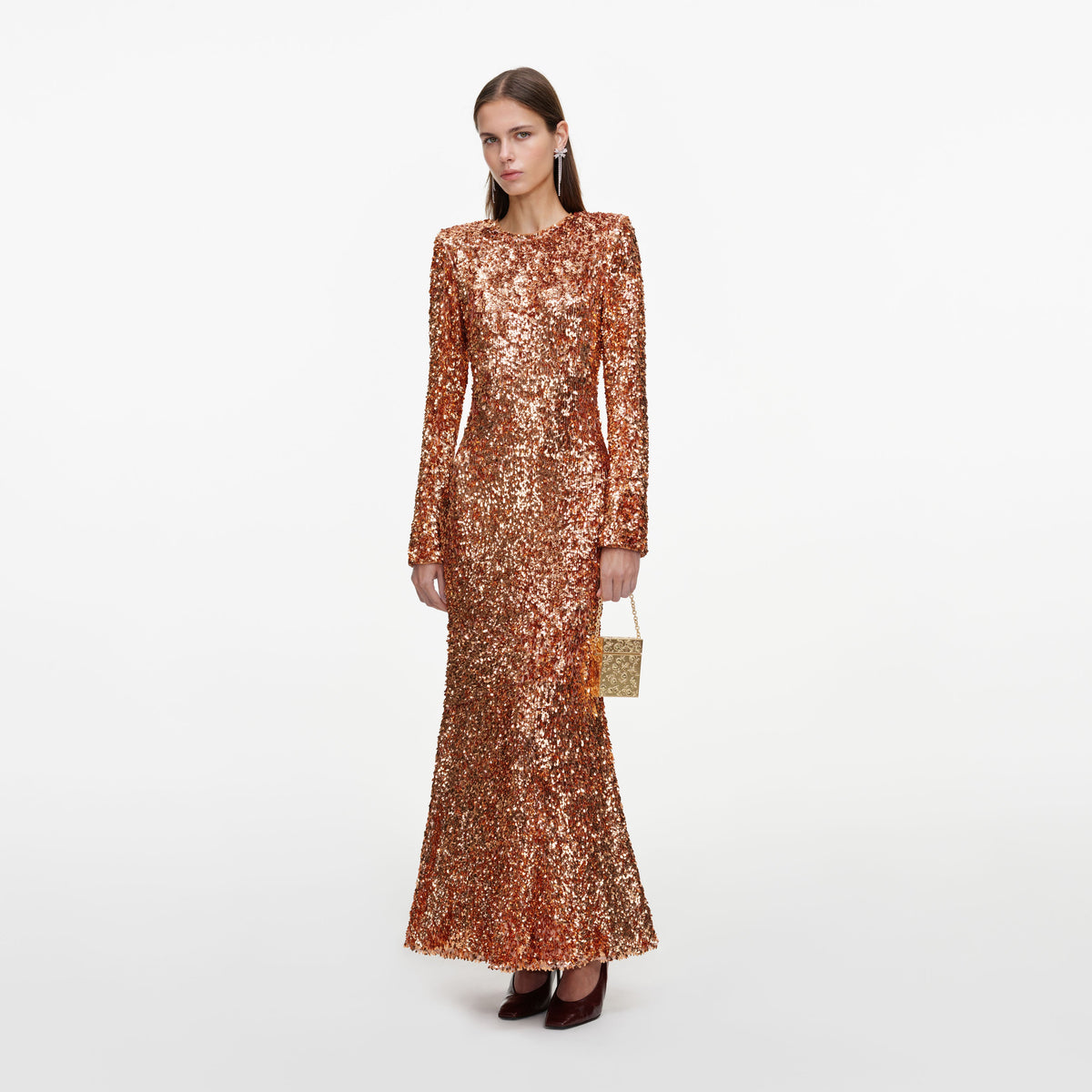 Side view of a woman wearing the Gold Sequin Maxi Dress