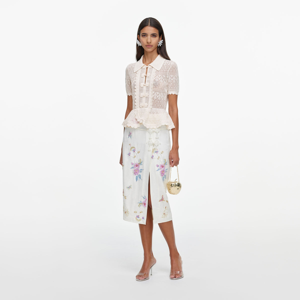 Side view of a woman wearing the Cream Pointelle Knit Wrap Peplum Top