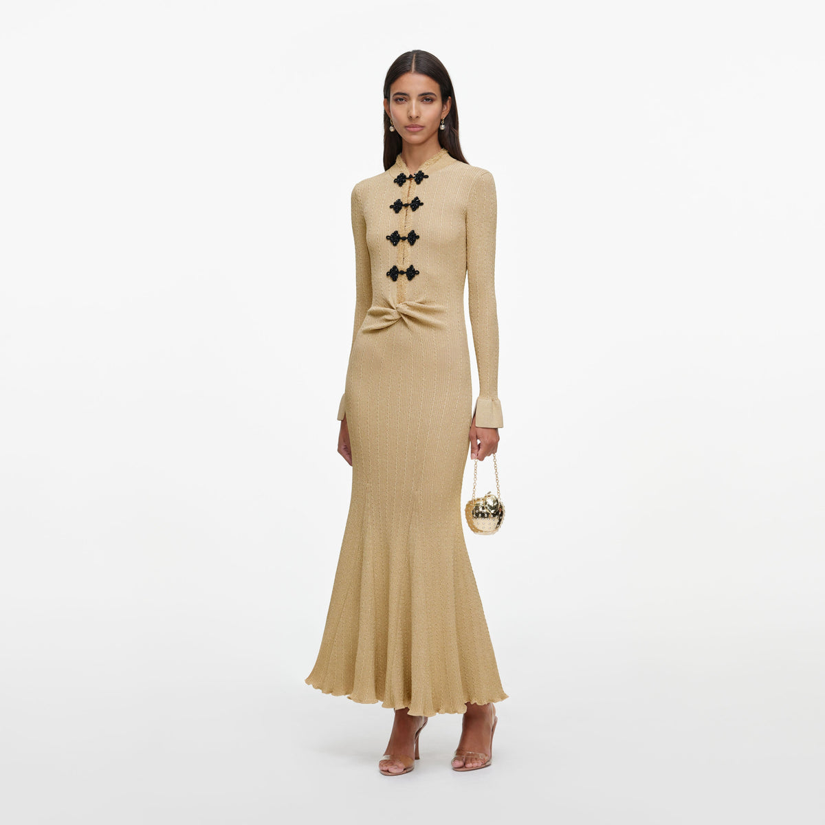 Side view of a woman wearing the Gold Metallic Knit Midi Dress