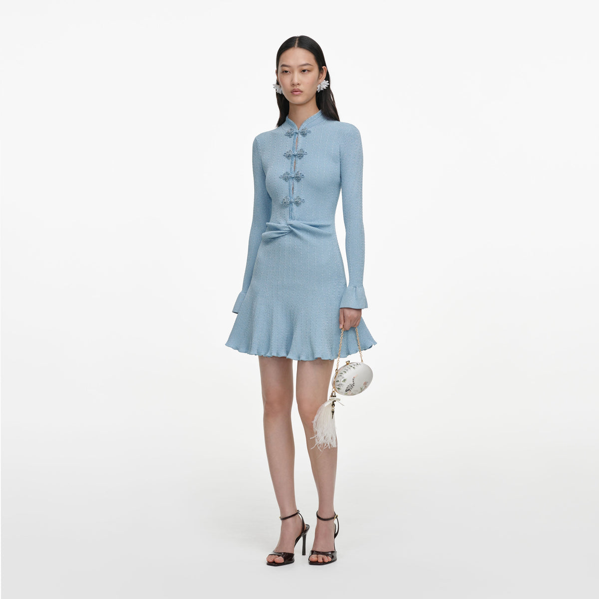 Side view of a woman wearing the Blue Metallic Knit Mini Dress
