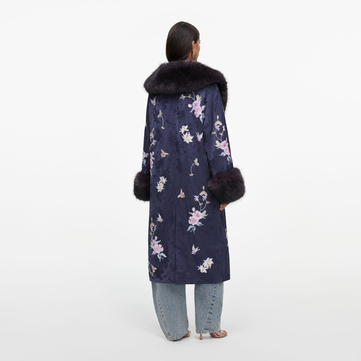 Back view of a woman wearing the Navy Floral Jacquard Fur Collar Coat
