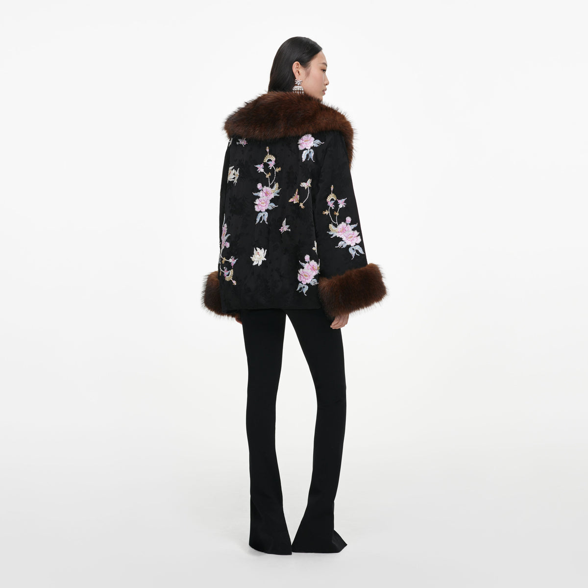Back view of a woman wearing the Black Floral Jacquard Fur Collar Coat