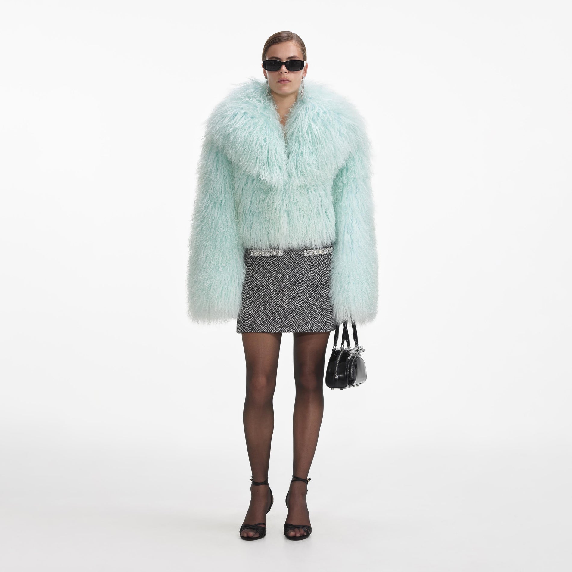 Side view of a woman wearing the Green Shearling Jacket