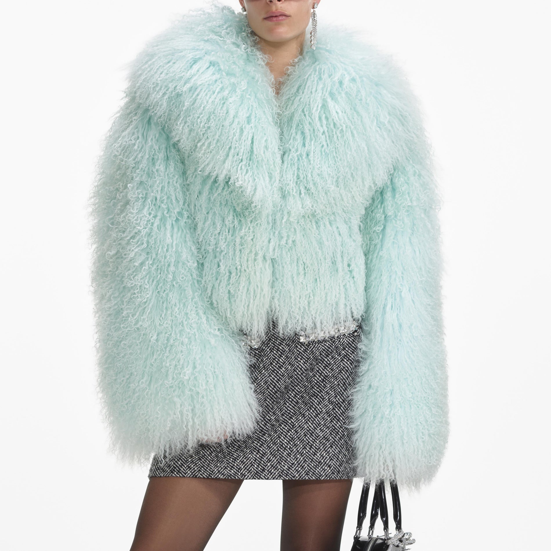 A close up of a woman wearing the Green Shearling Jacket