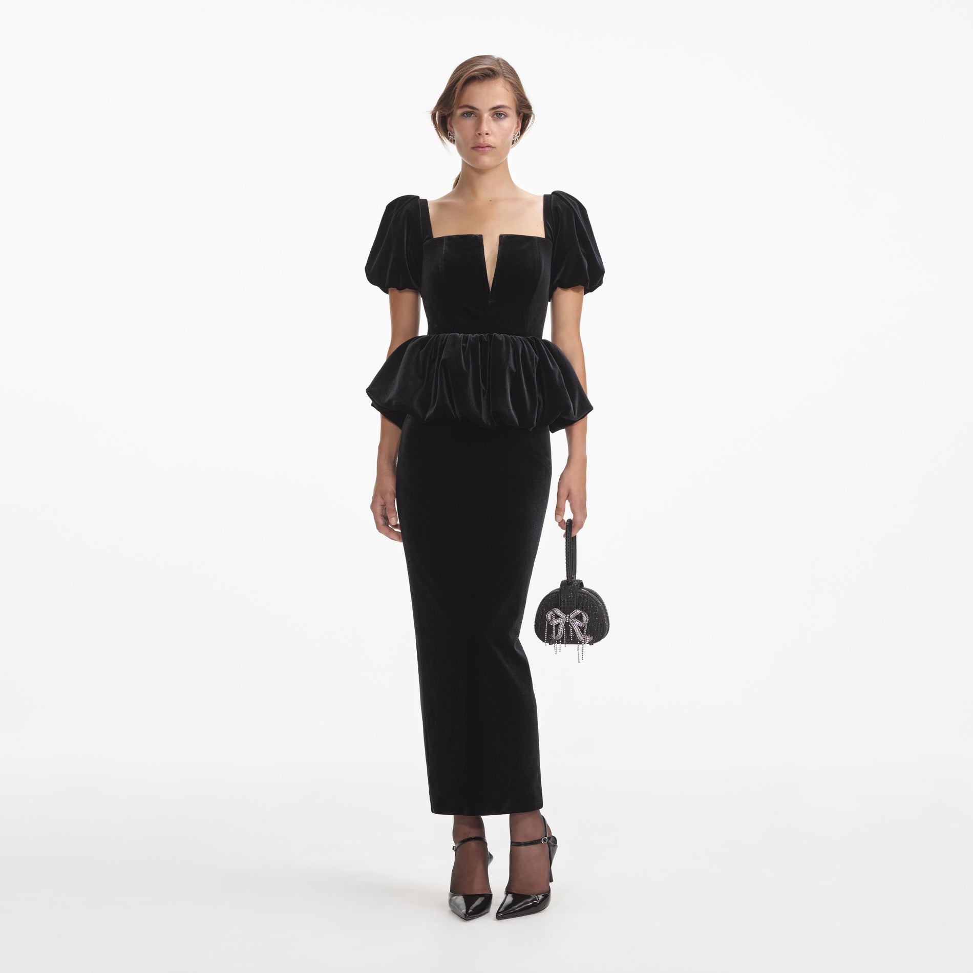 Front view of a woman wearing the Black Velvet Peplum Midi Dress