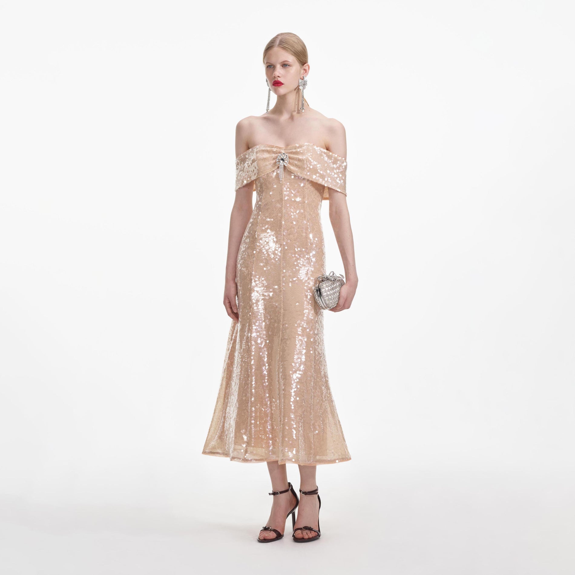 Side view of a woman wearing the Gold Sequin Off Shoulder Midi Dress