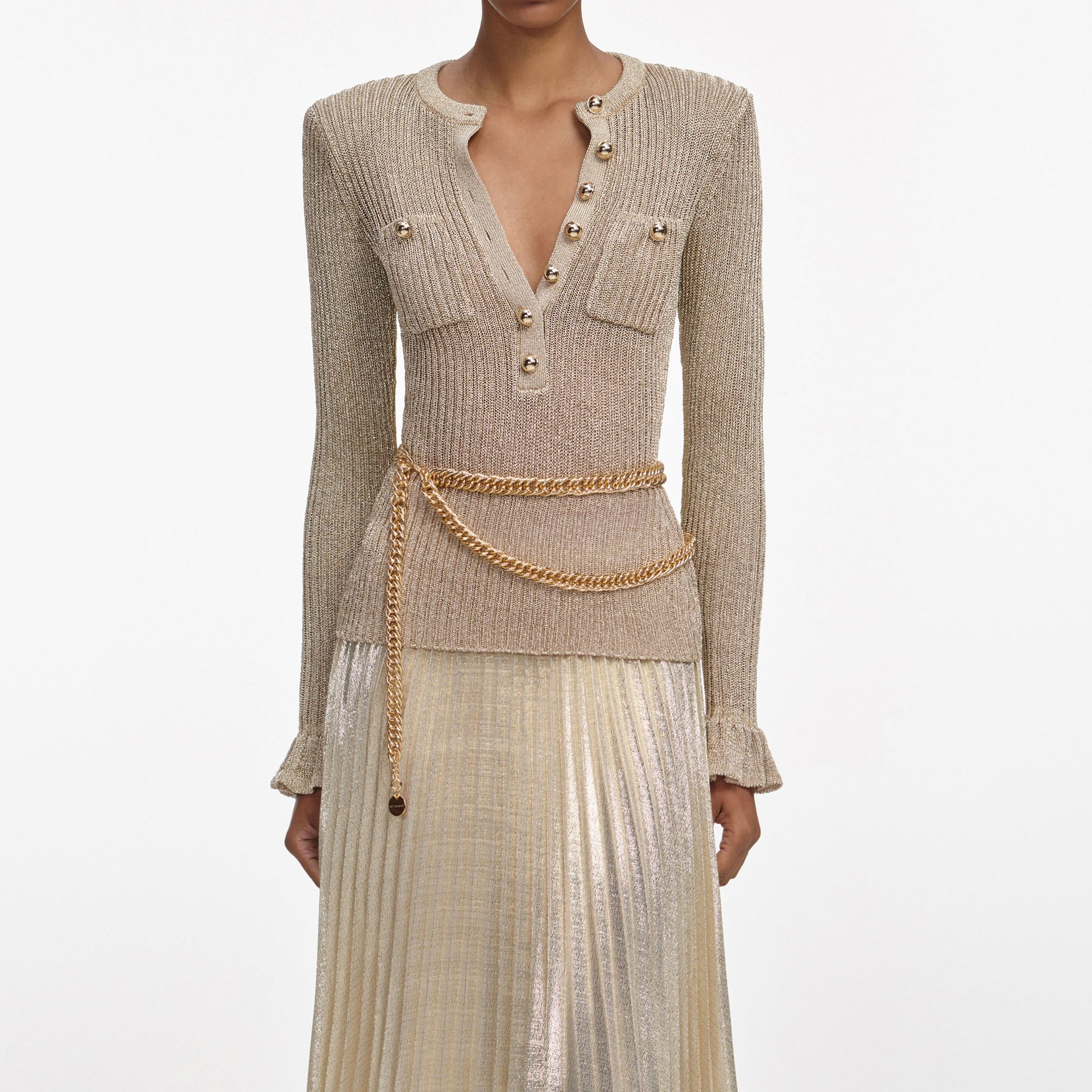 A close up of a woman wearing the Gold Lurex Ribbed Knit Maxi Dress