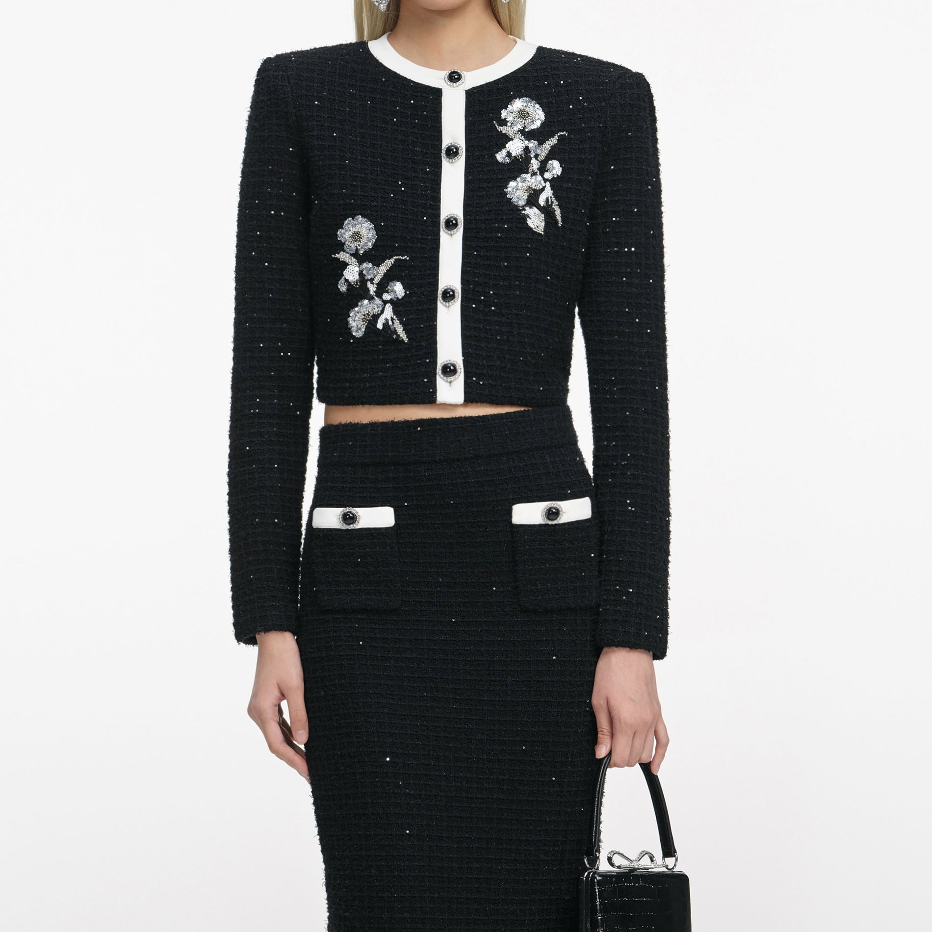 A close up of a woman wearing the Black Textured Knit Midi Skirt