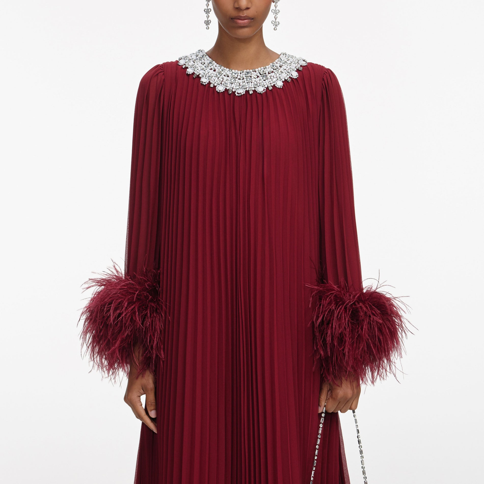 A close up of a woman wearing the Burgundy Chiffon Feather Midi Dress