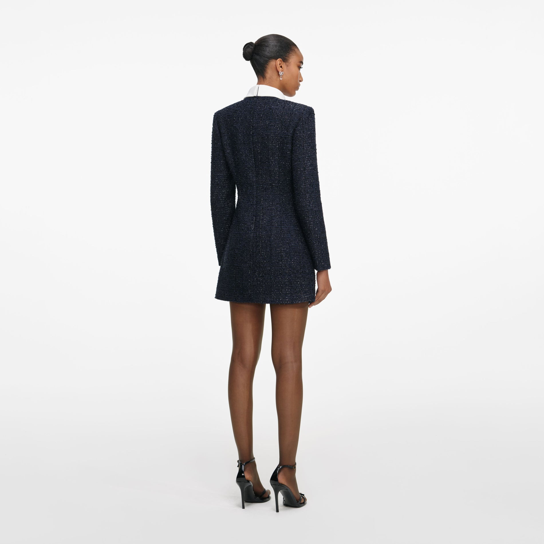 Back view of a woman wearing the Navy Boucle Long Sleeve Mini Dress