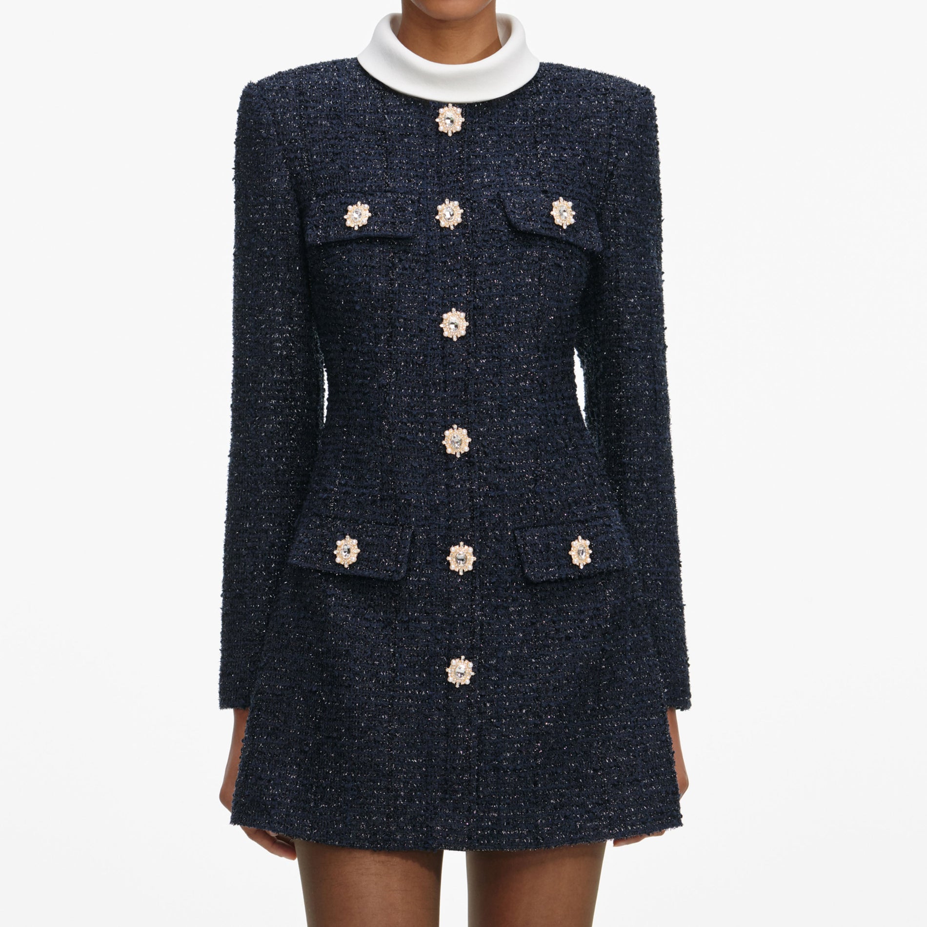 A close up of a woman wearing the Navy Boucle Long Sleeve Mini Dress
