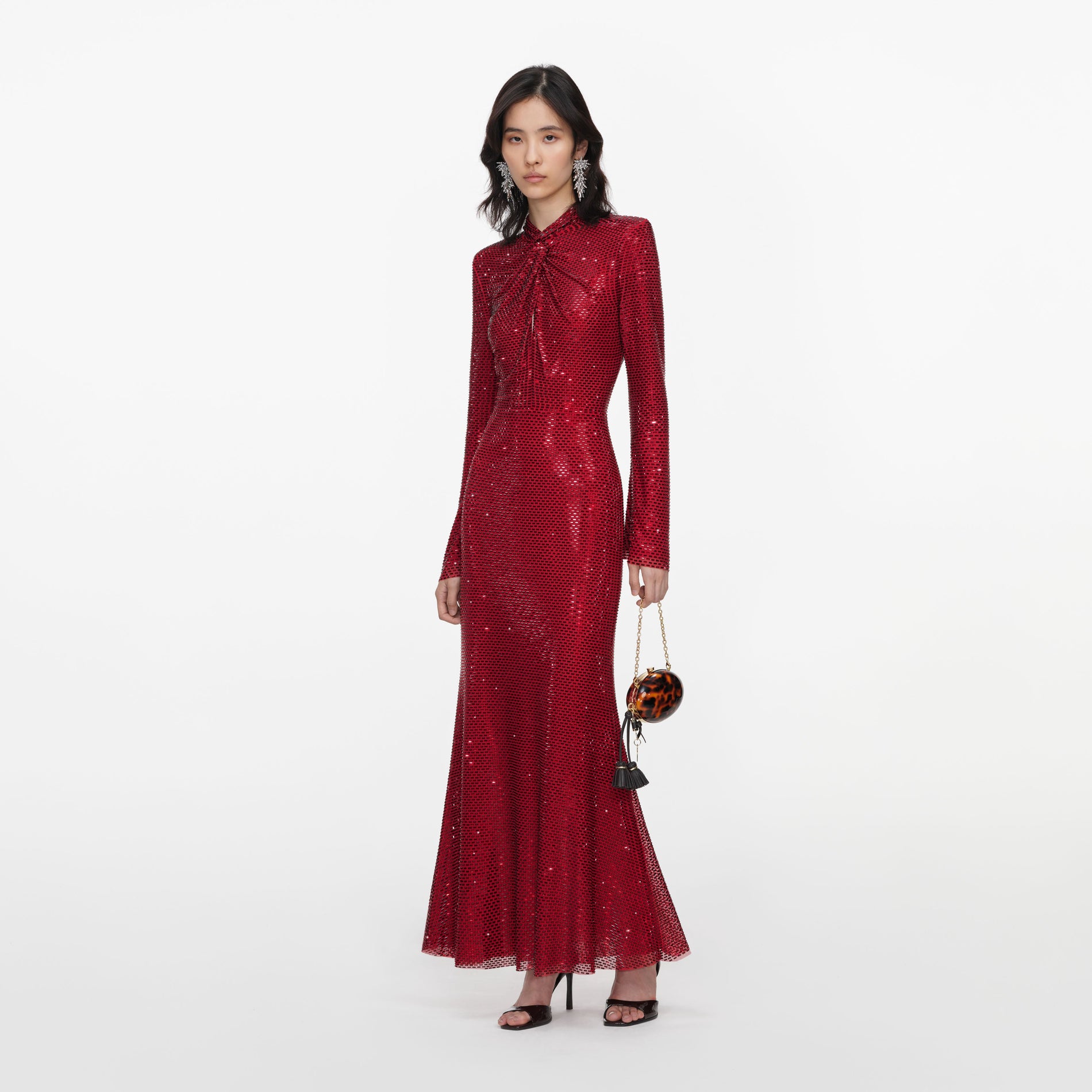 Side view of a woman wearing the Red Rhinestone Mesh Twist Midi Dress