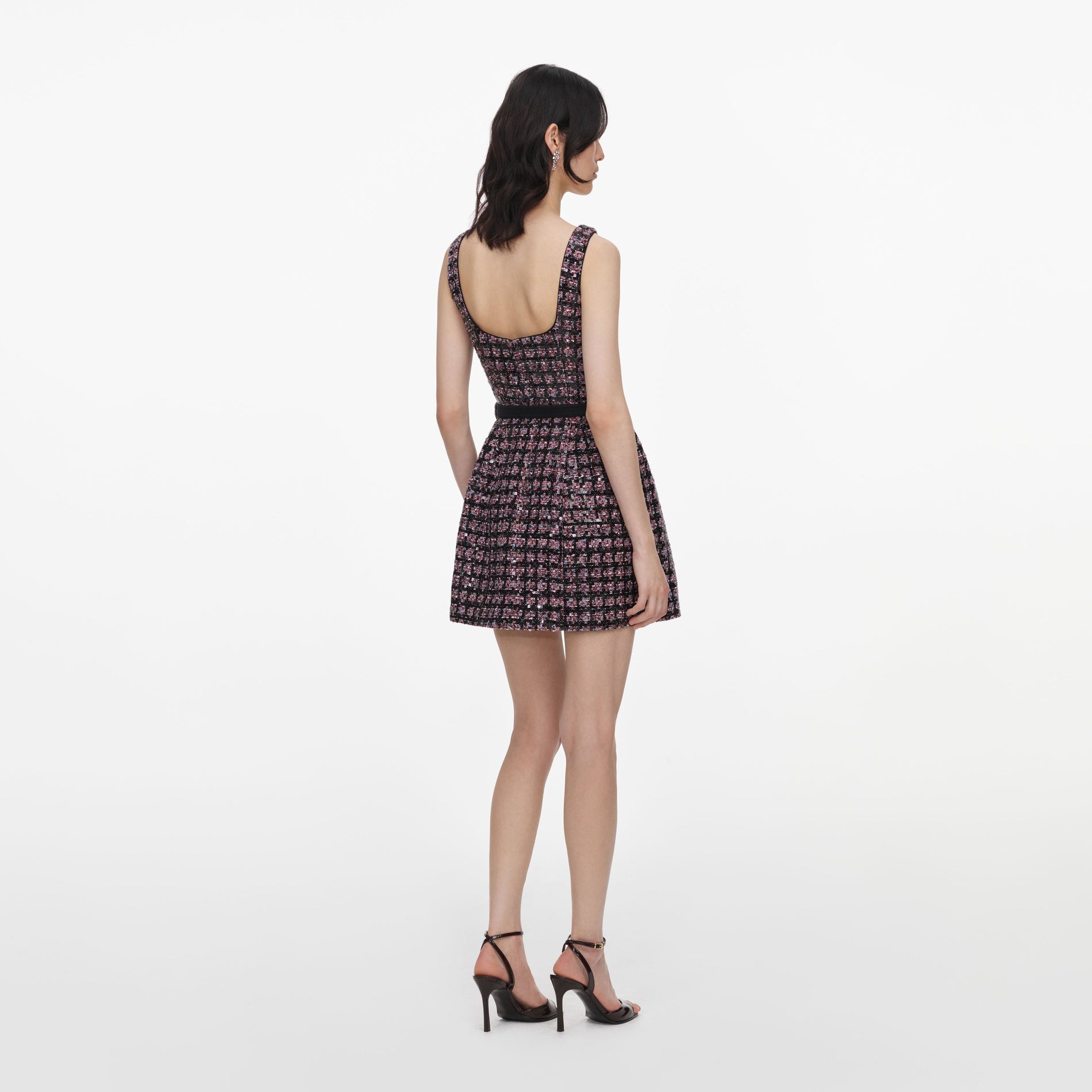 Back view of a woman wearing the Pink and Black Sequin Boucle Sleeveless Mini Dress