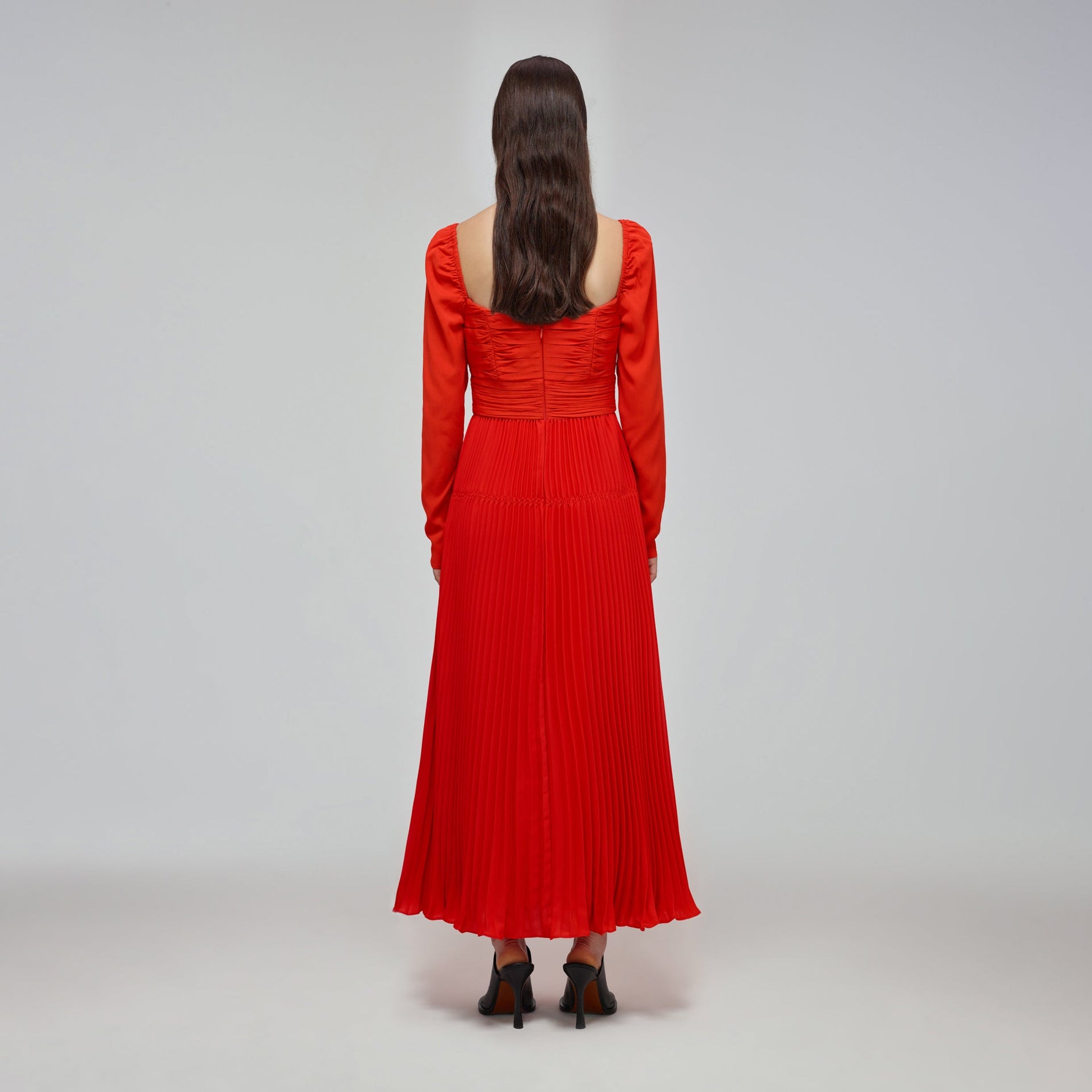 A woman wearing the Red Stretch Crepe Cut Out Midi Dress