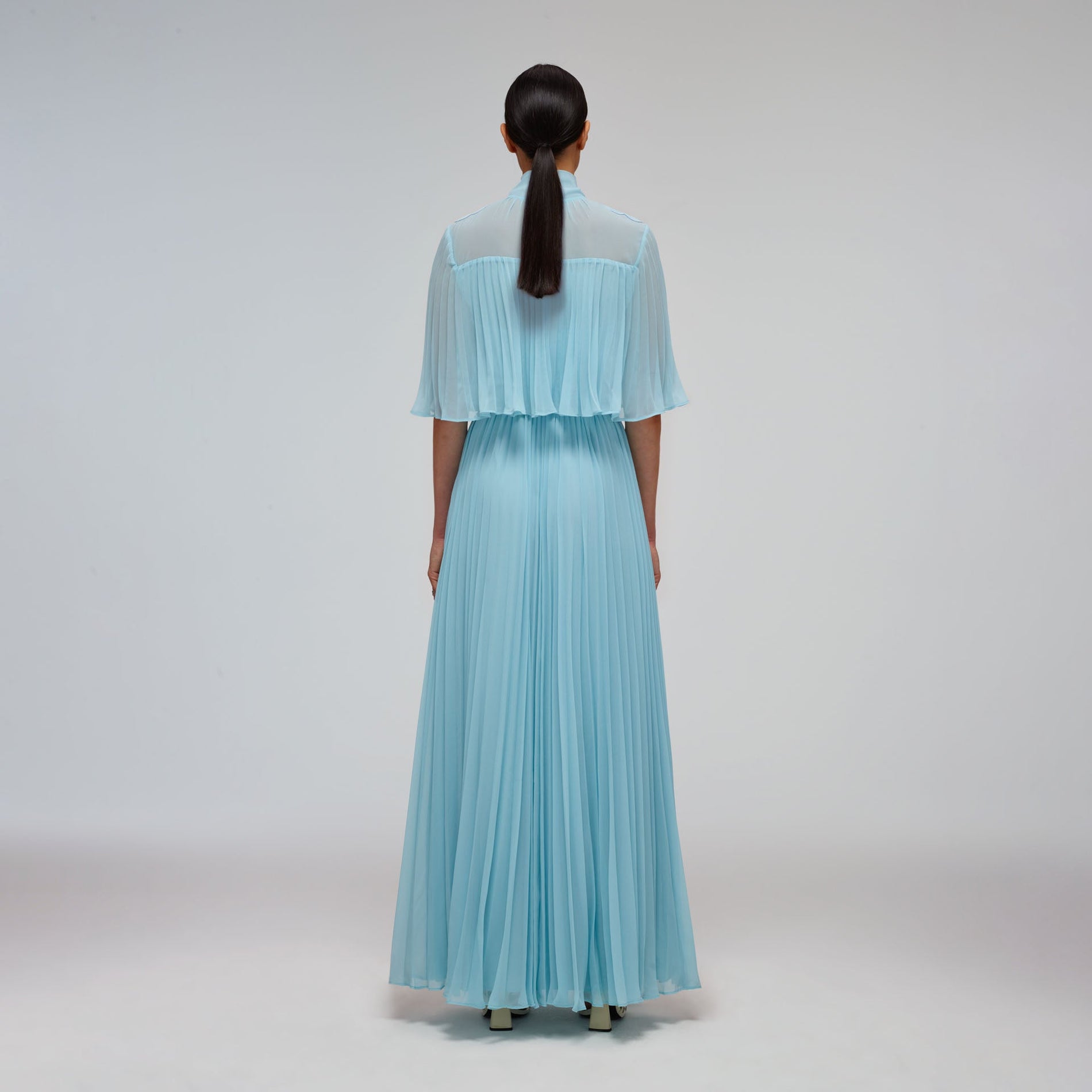 A woman wearing the Tropical Blue Chiffon Maxi Dress