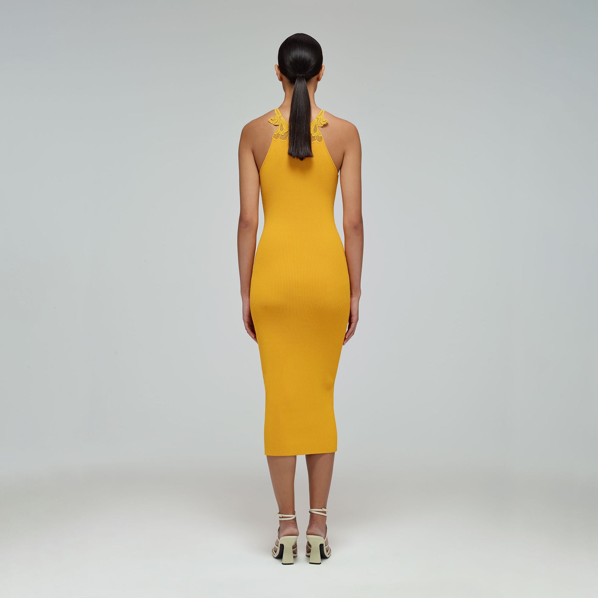 A woman wearing the Canary Yellow Inserted Lace Knit Dress