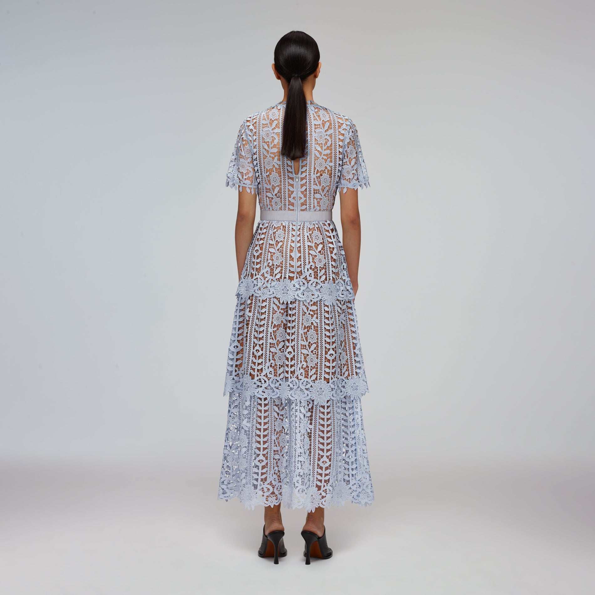 A woman wearing the Blue Tiered Guipure Lace Midi Dress