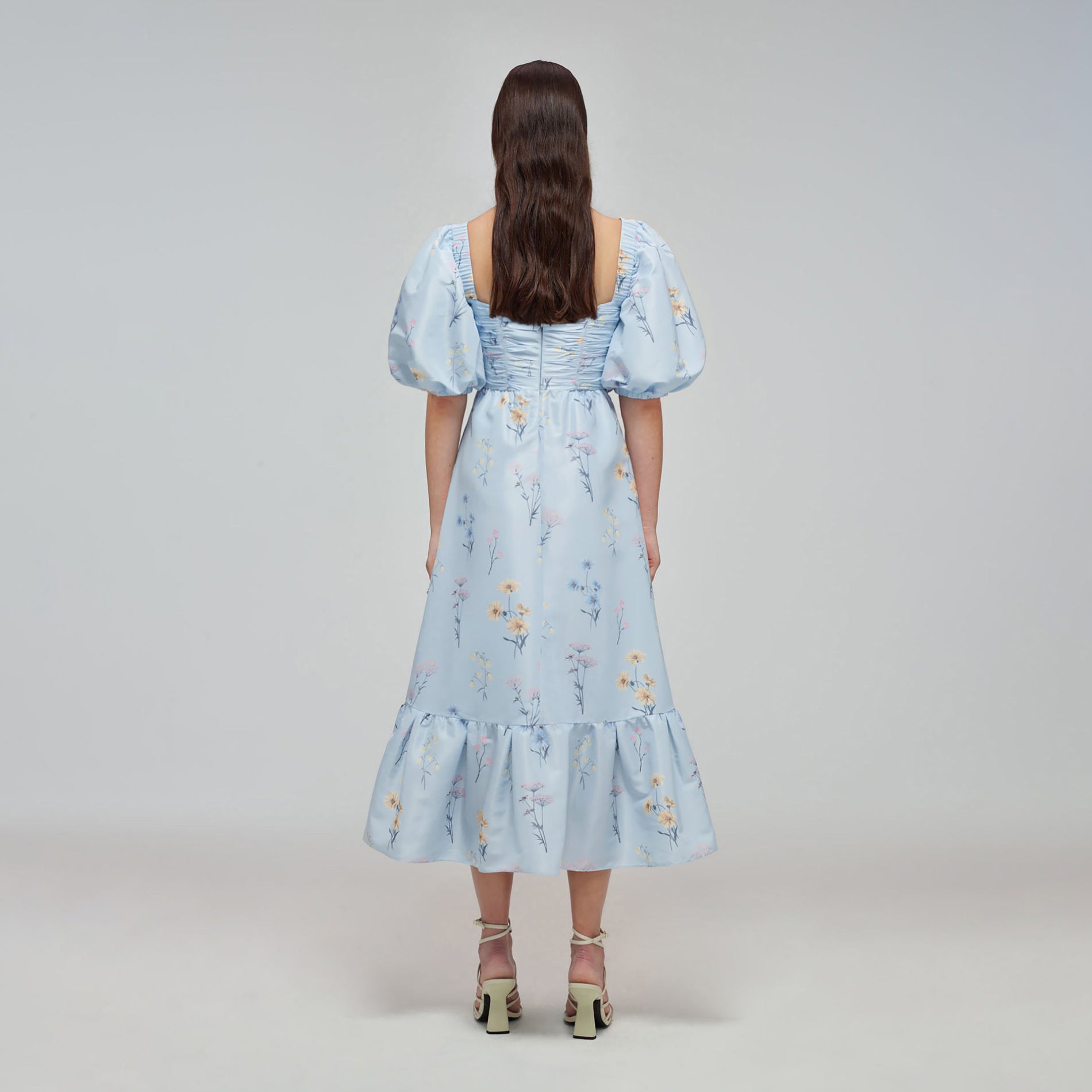 A woman wearing the Blue Floral Watercolour Taffeta Midi Dress