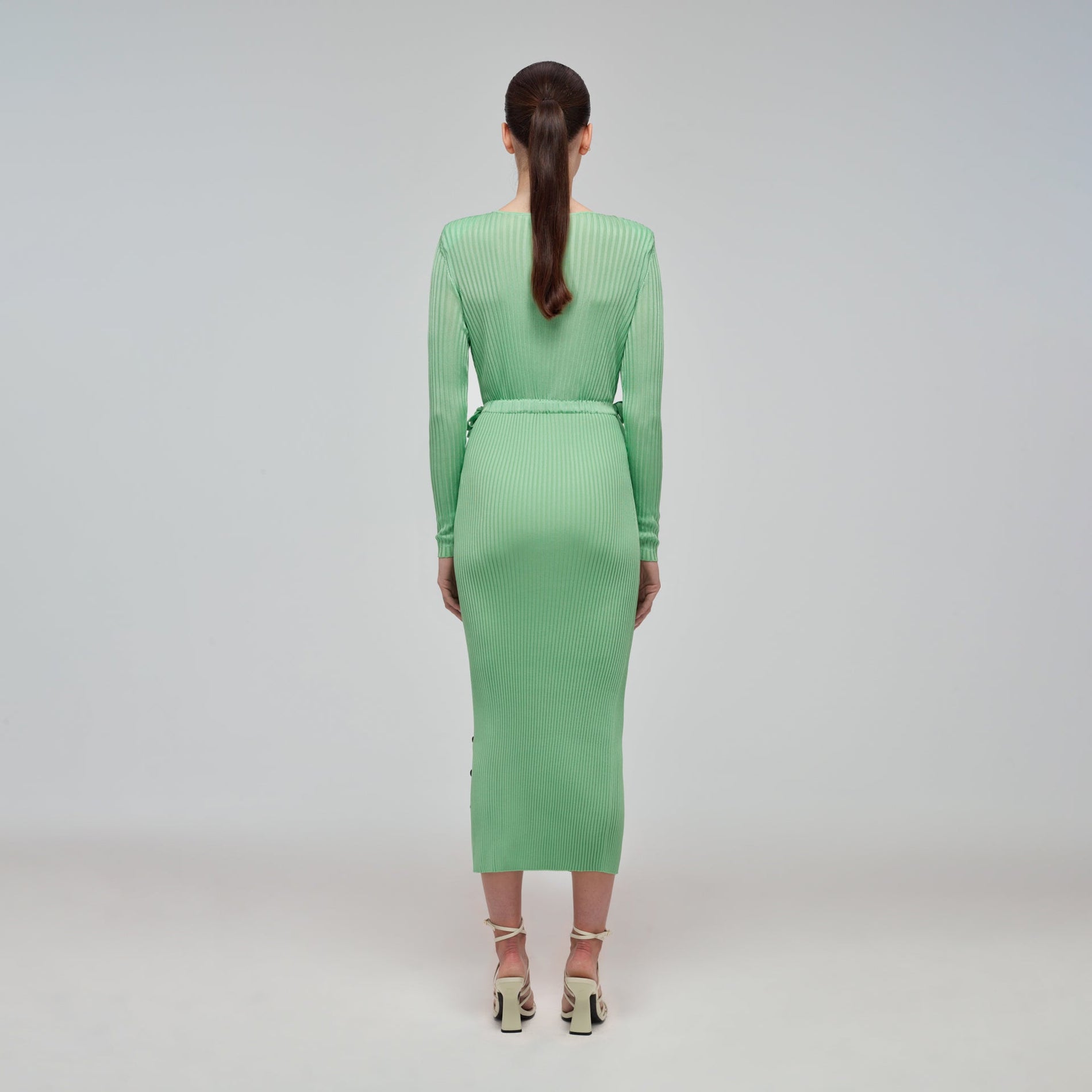 A woman wearing the Spearmint Ribbed Knit Midi Dress