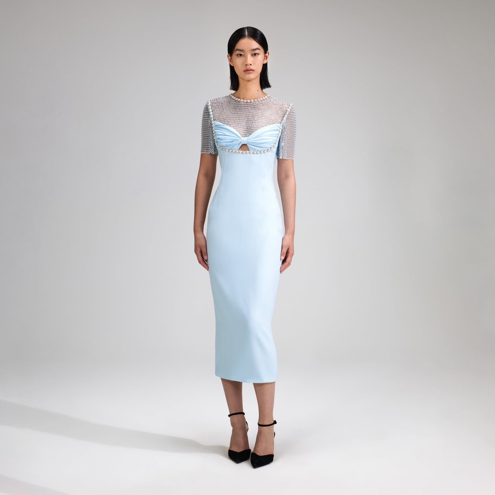 A woman wearing the Blue Crepe Diamante Midi Dress