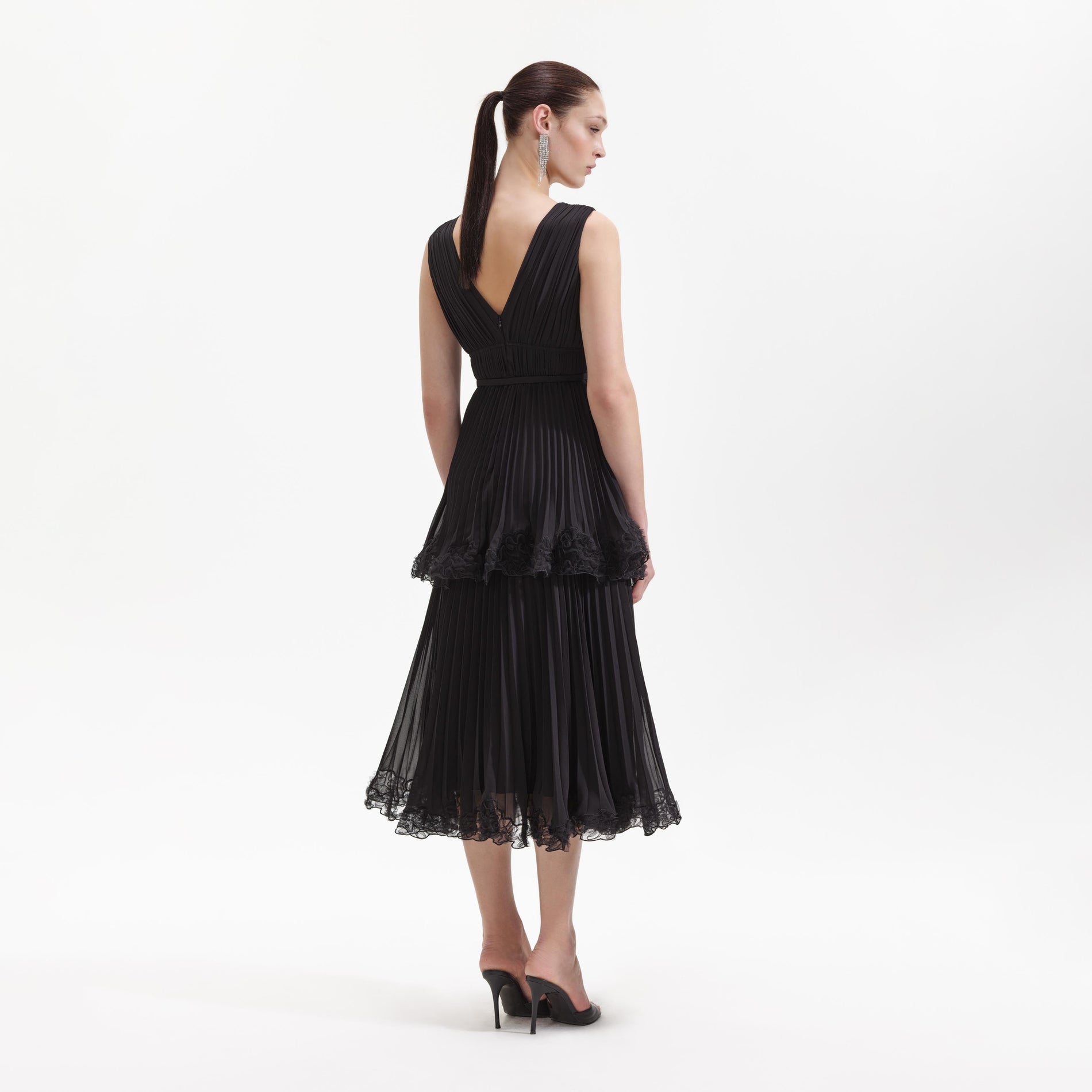 A Woman wearing the Black Chiffon Tier Midi Dress