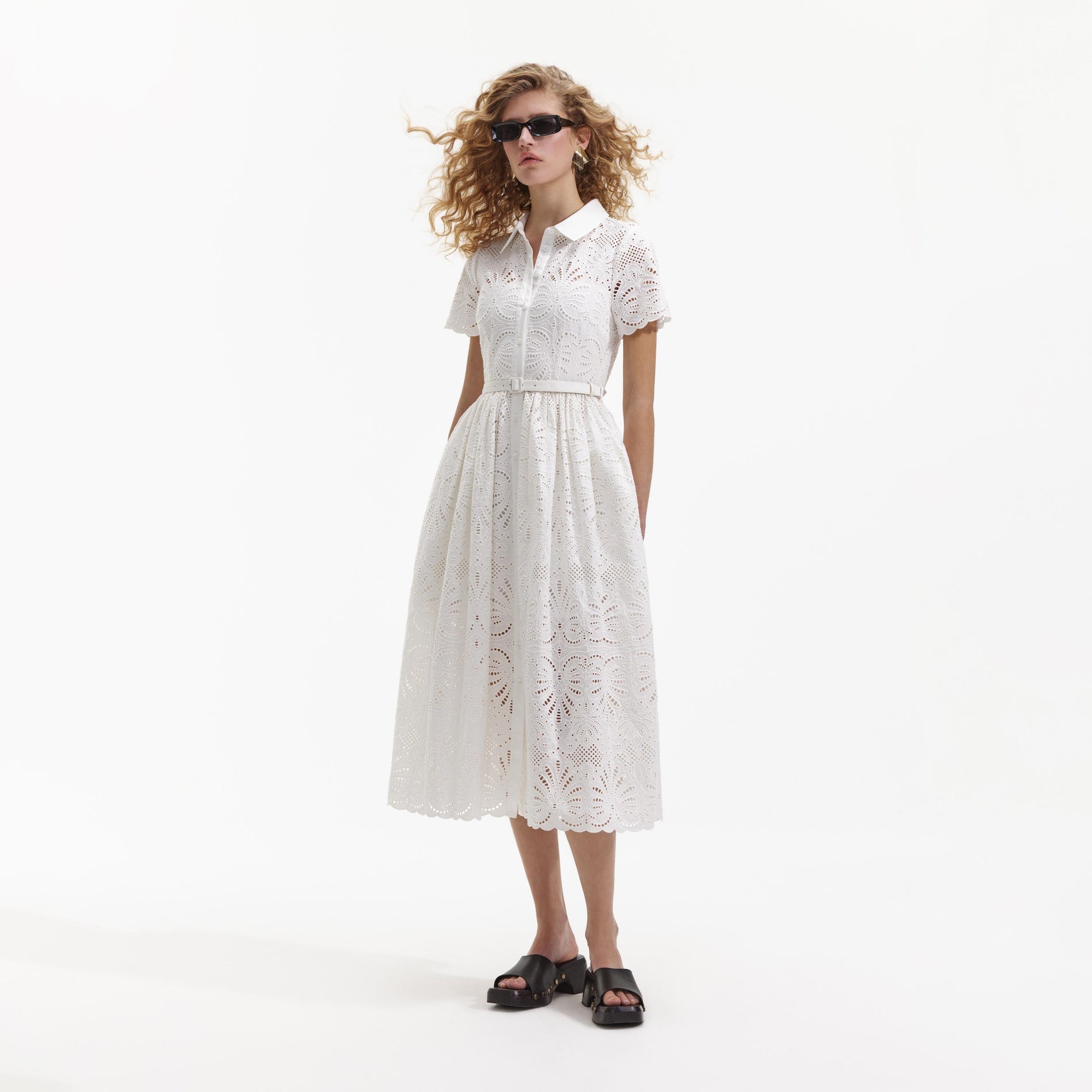 Side view of a woman wearing the White Cotton Embroidery Midi Dress