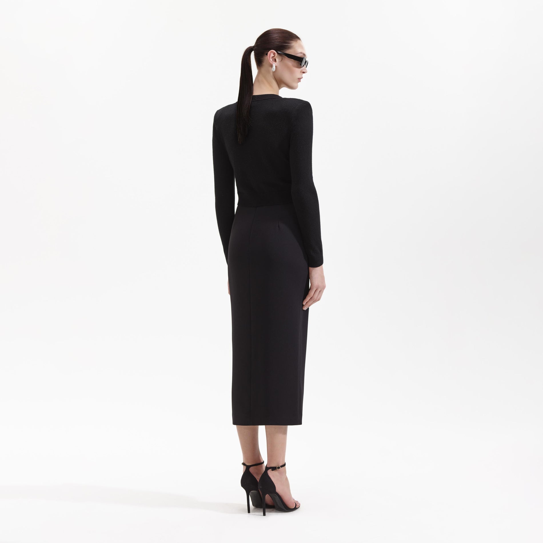 A Woman wearing the Black Crepe Midi Skirt