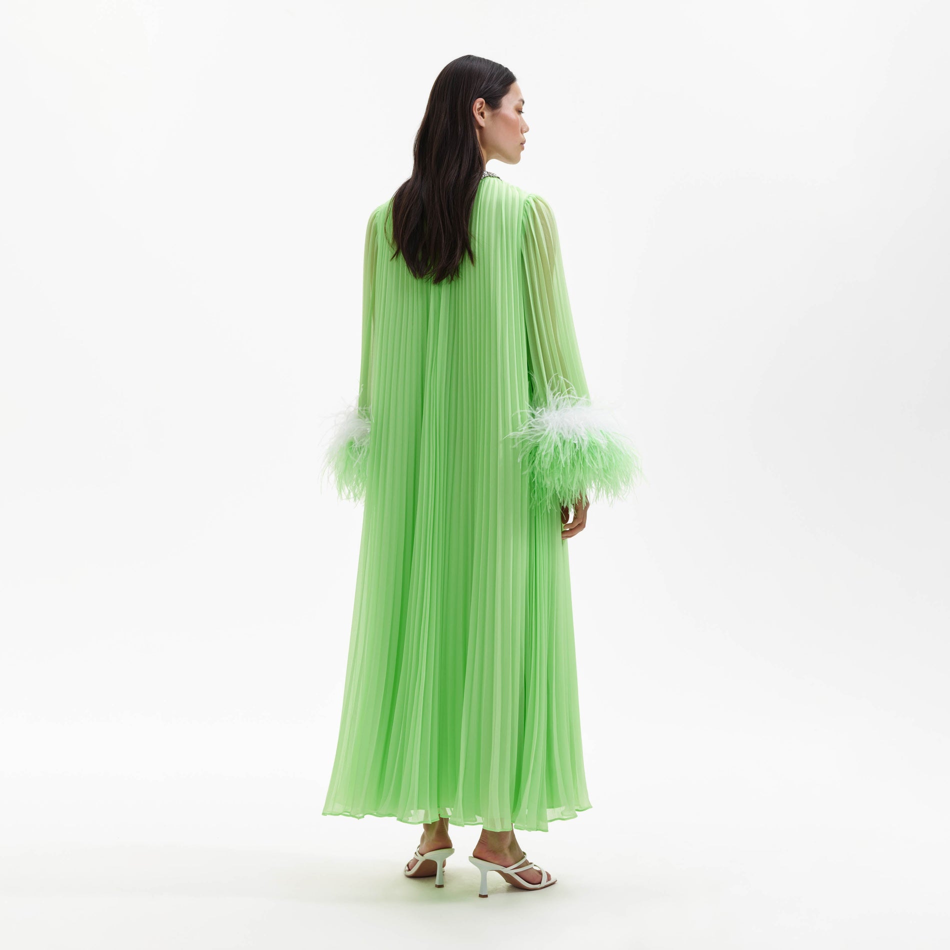 Back view of a woman wearing the Green Chiffon Feather Midi Dress