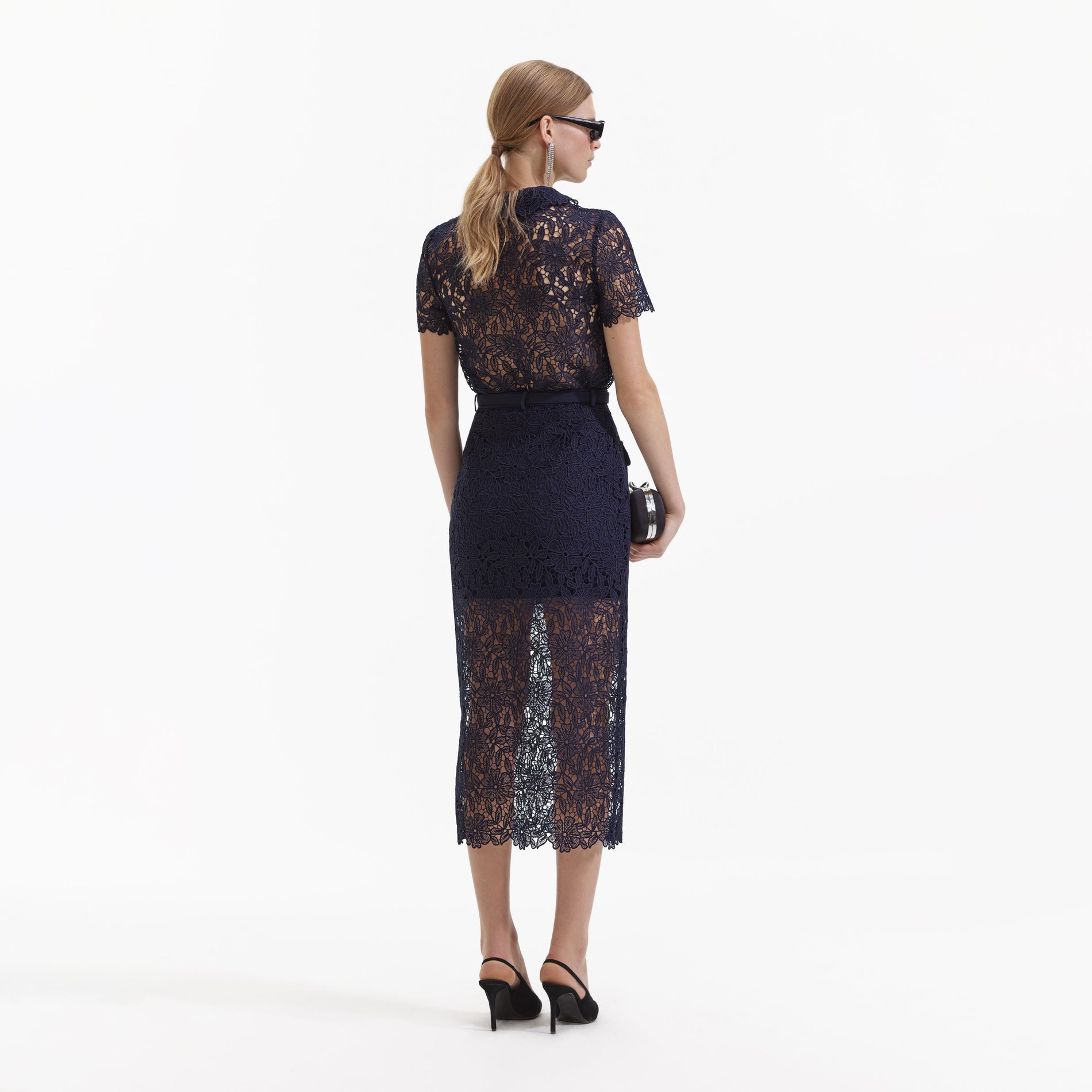 A Woman wearing the Navy Guipure Lace Midi Skirt
