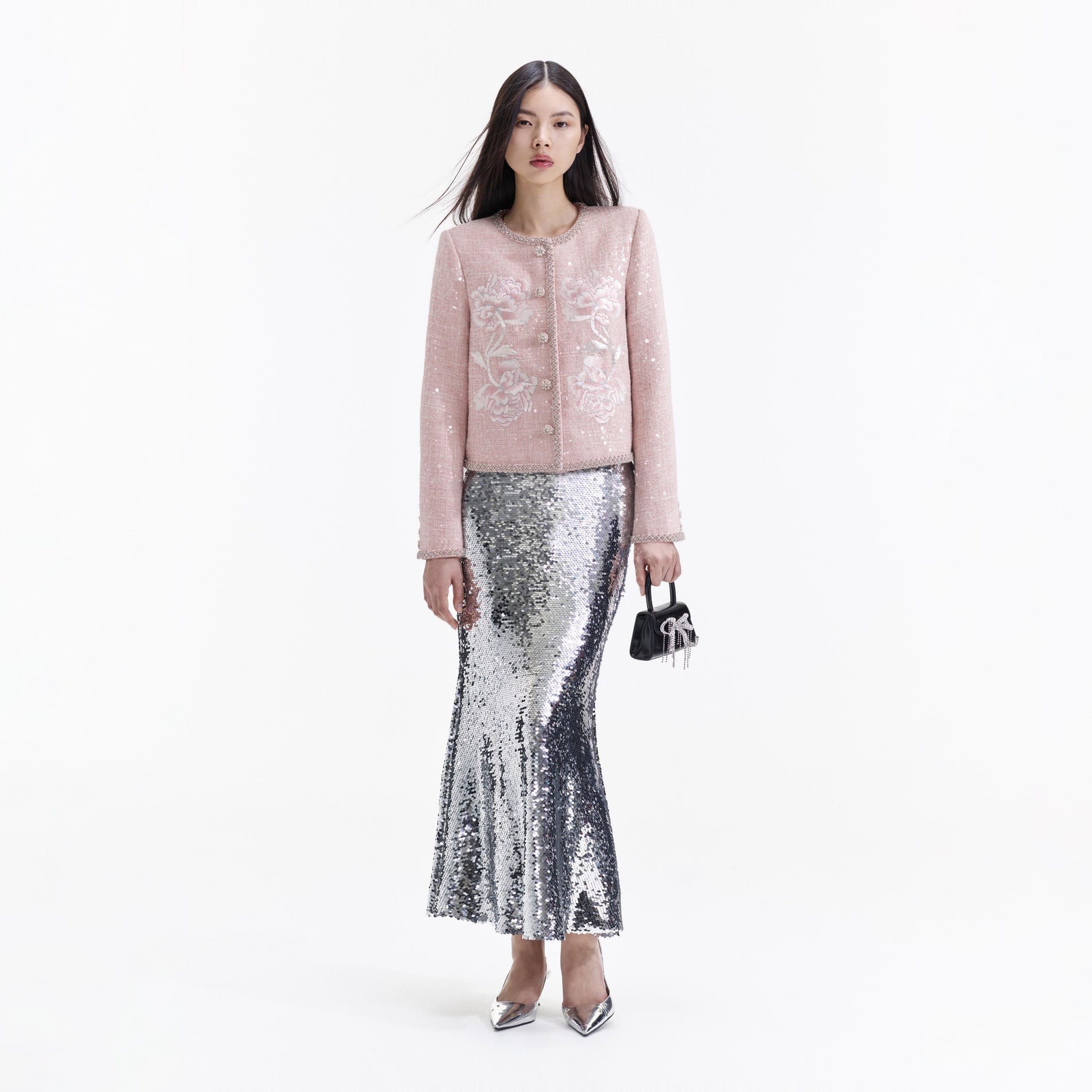 A Woman wearing the Pink Hand Embroidered Peony Boucle Jacket