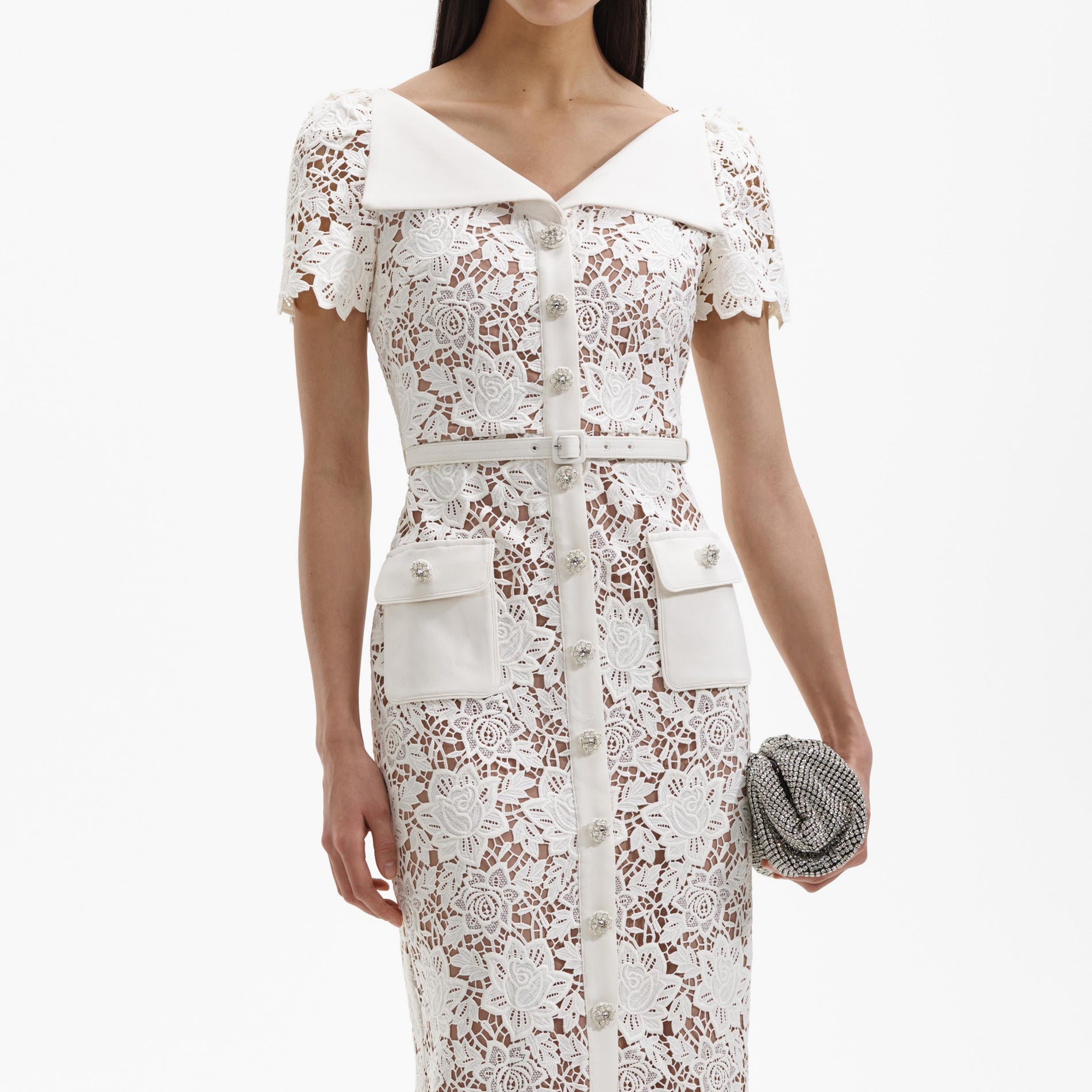 A close up of a woman wearing the White Lace Open Neck Midi Dress