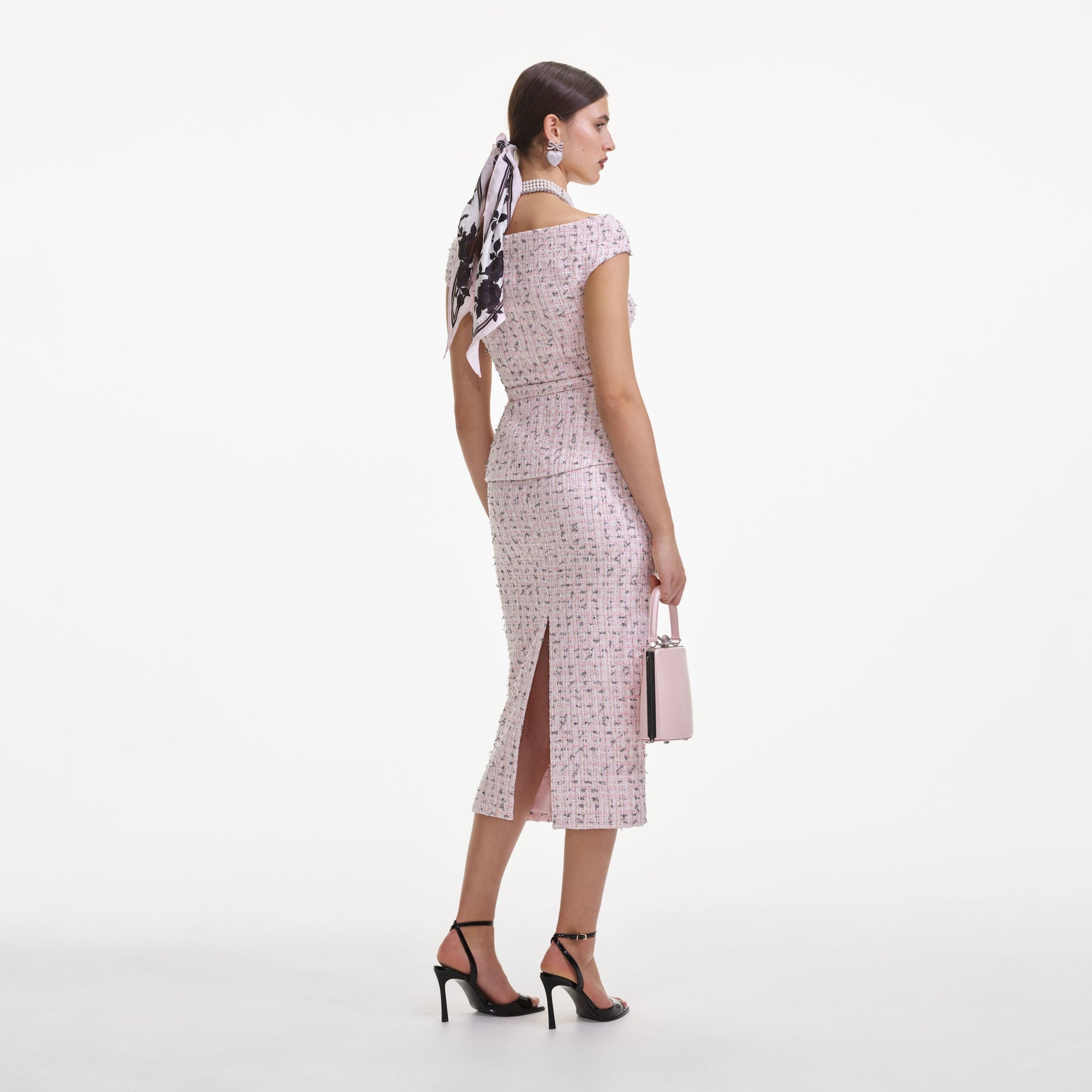 Back view of a woman wearing the Pink Boucle Pearl Midi Dress