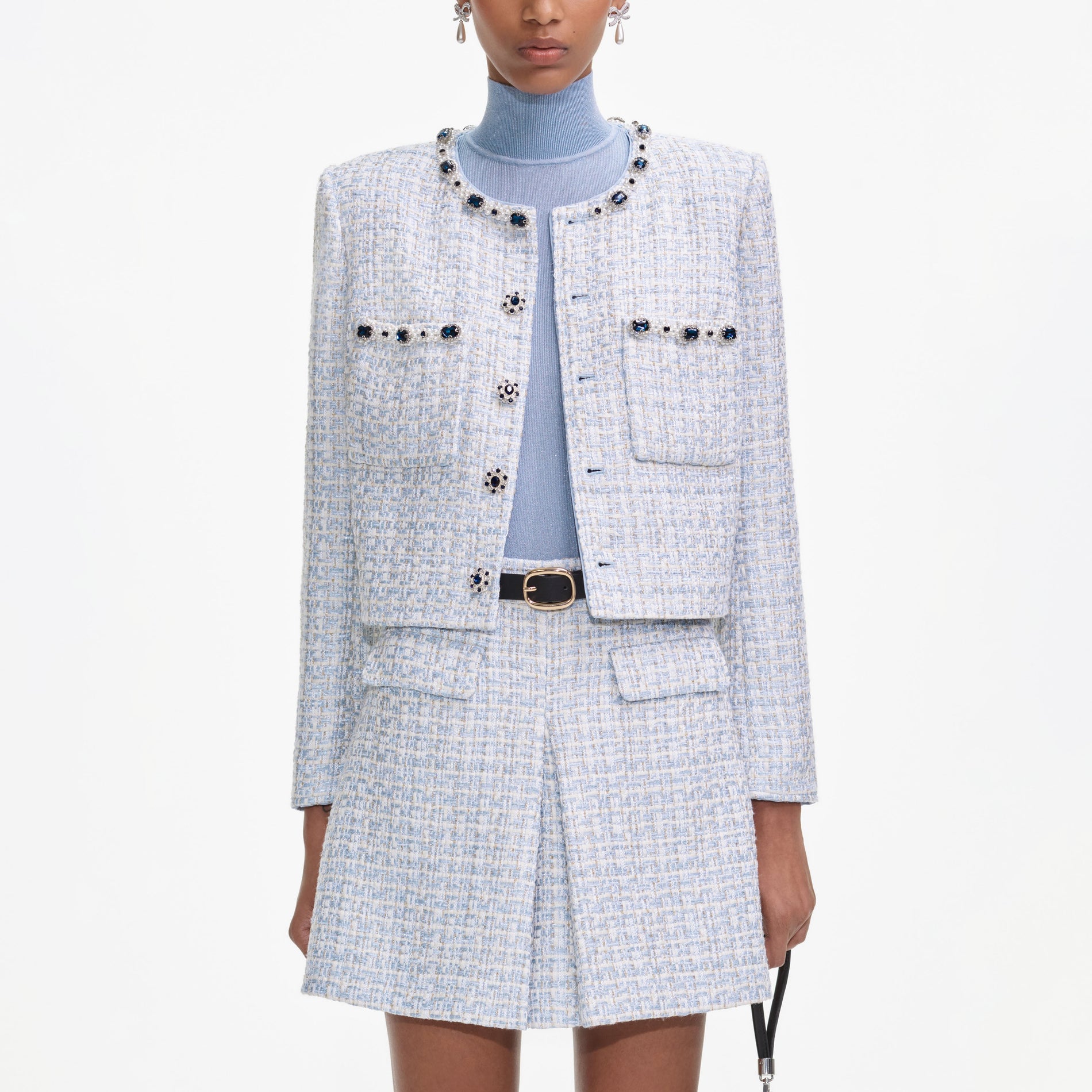 A close up of a woman wearing the Blue Boucle Mini Skirt