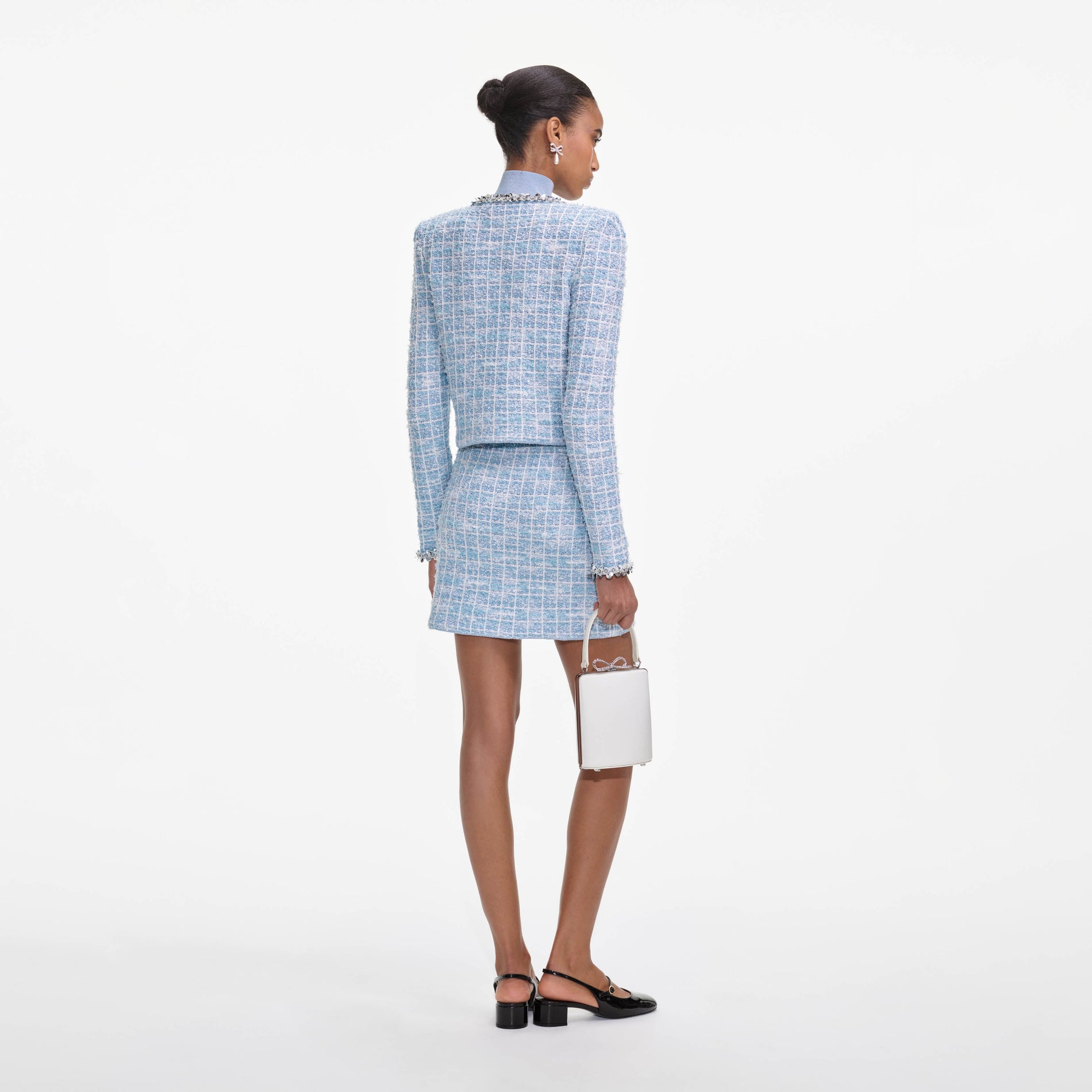 Back view of a woman wearing the Blue Check Knit Mini Skirt