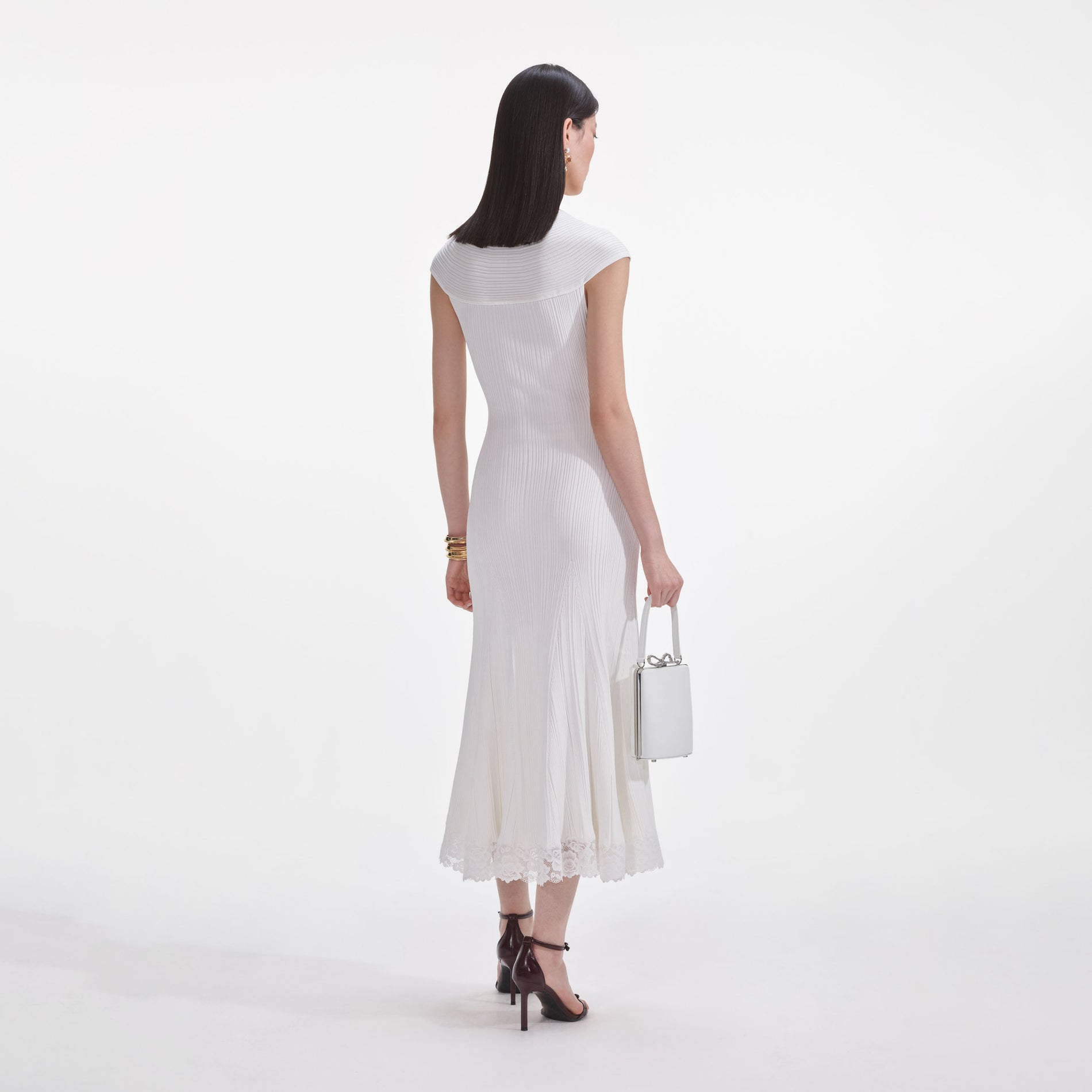 Back view of a woman wearing the White Knit Lace Insert Midi Dress