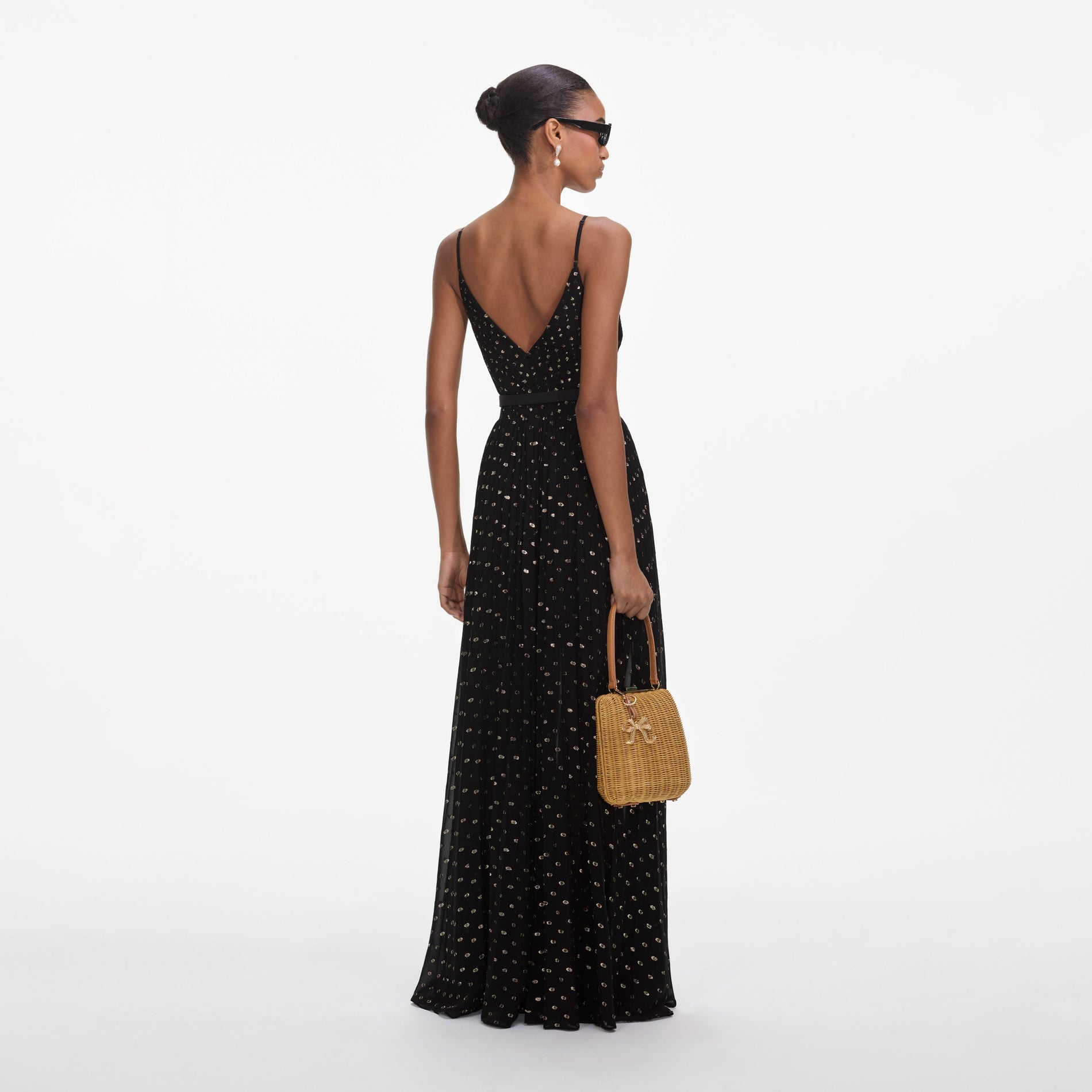 Back view of a woman wearing the Black And Gold Chiffon Maxi Dress