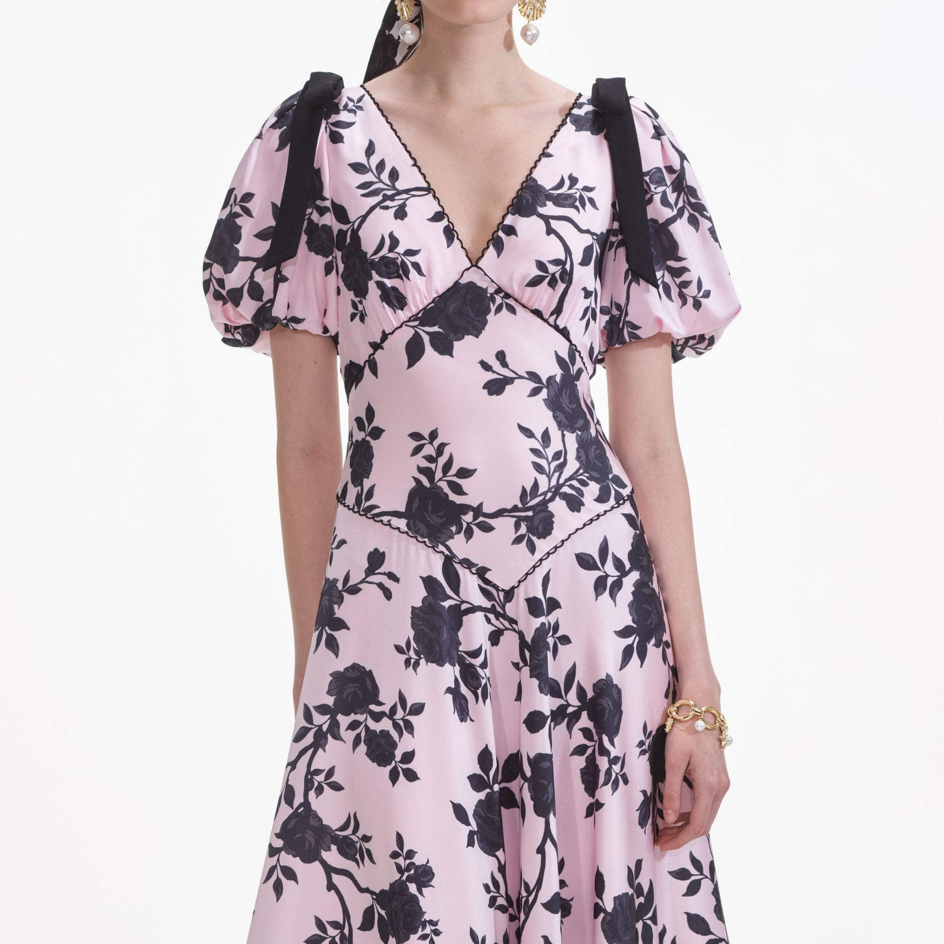 A close up of a woman wearing the Pink Satin Floral Midi Dress