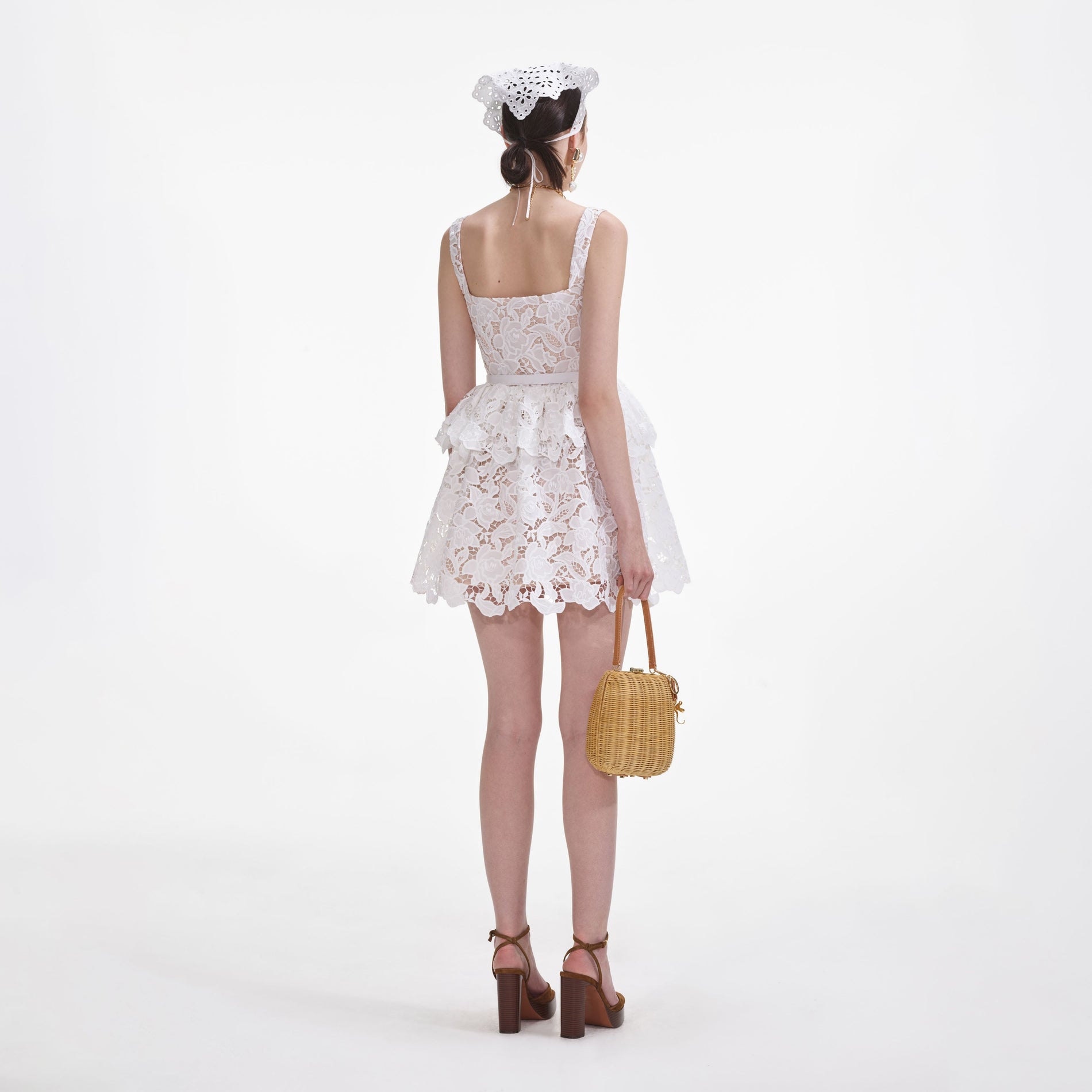 Back view of a woman wearing the White Lace Tiered Mini Dress