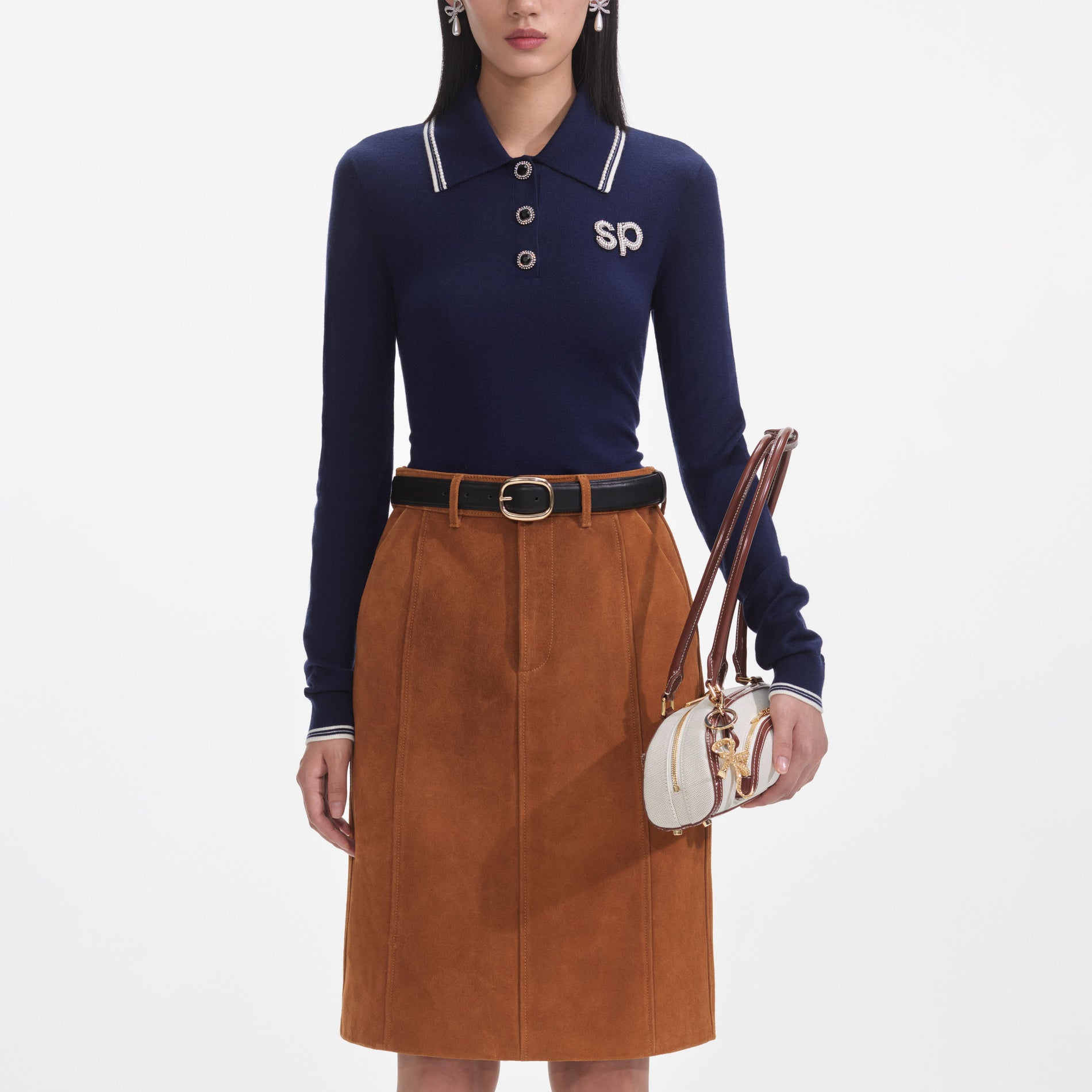 A close up of a woman wearing the Brown Suede Midi Skirt