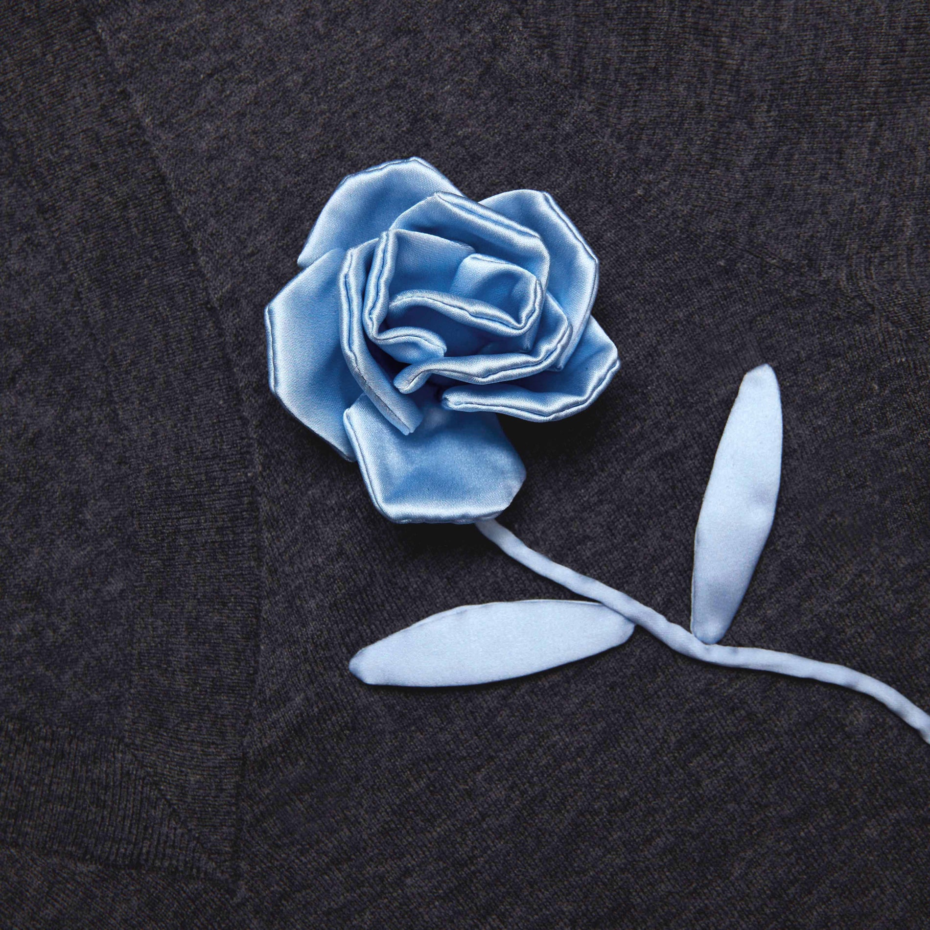 Side view of a woman wearing the Charcoal Blue Rose Lightweight Jumper