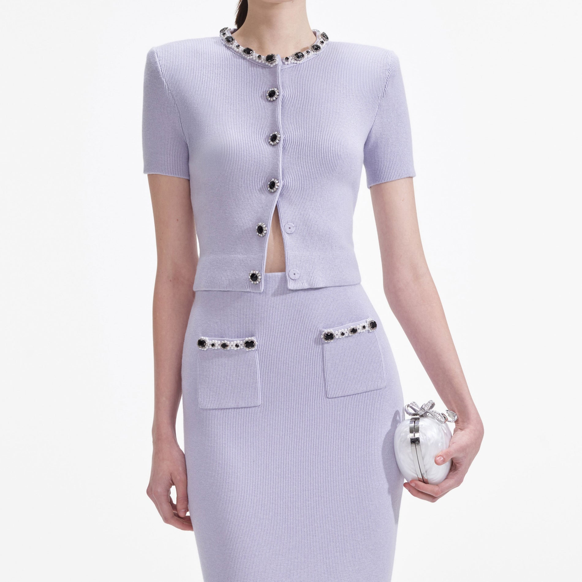 A close up of a woman wearing the Lilac Embellished Knit Midi Skirt