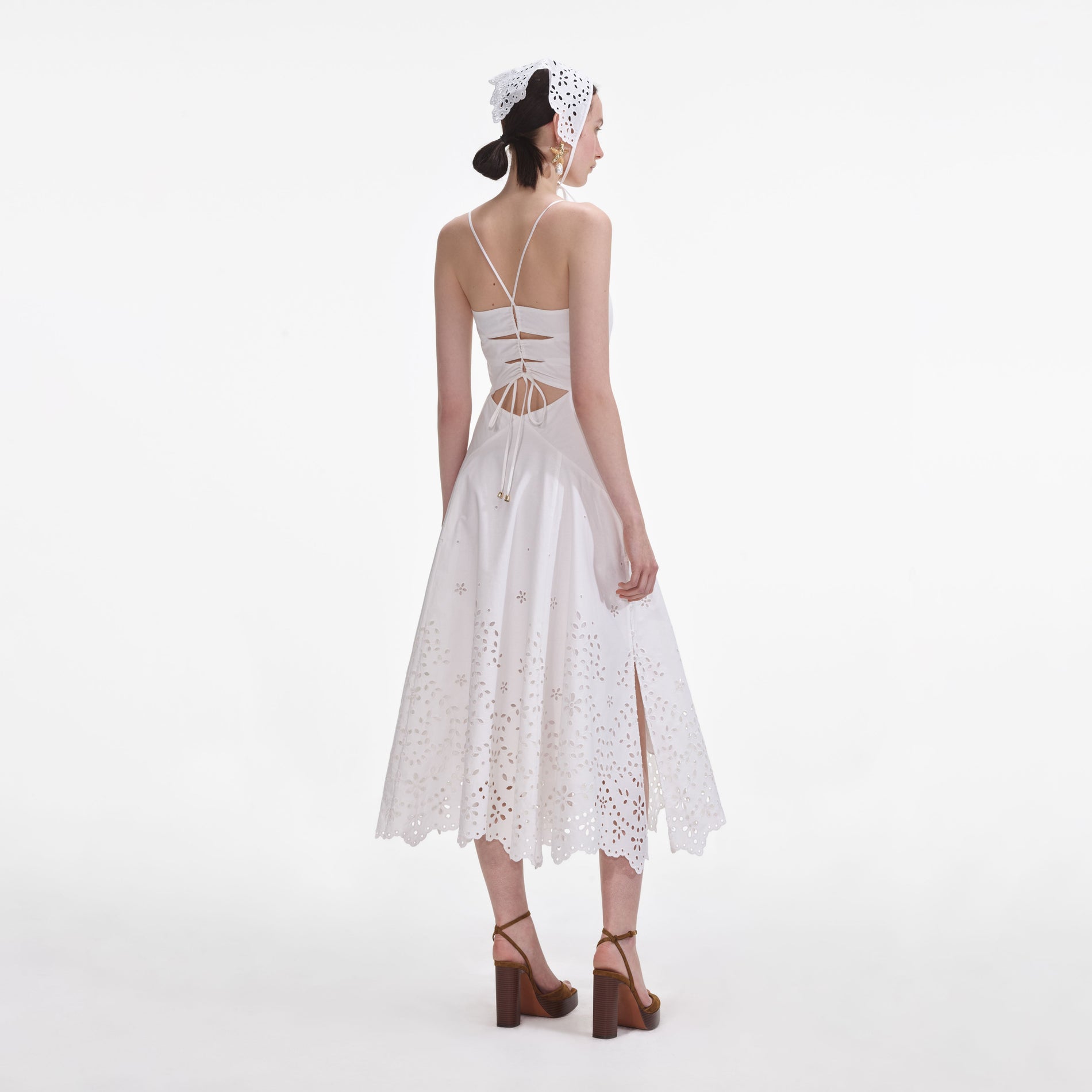 Back view of a woman wearing the White Cotton Embroidered Midi Dress