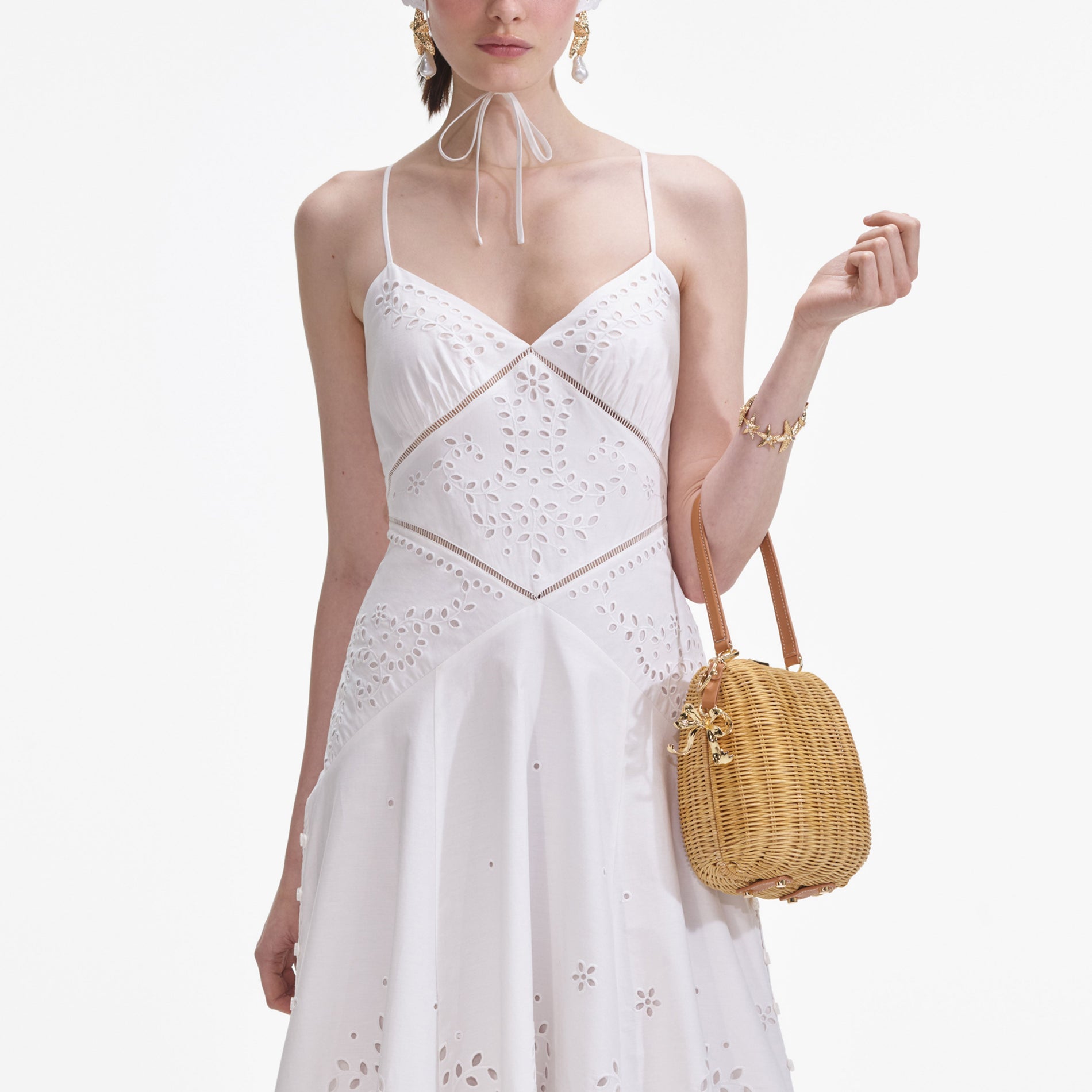A close up of a woman wearing the White Cotton Embroidered Midi Dress