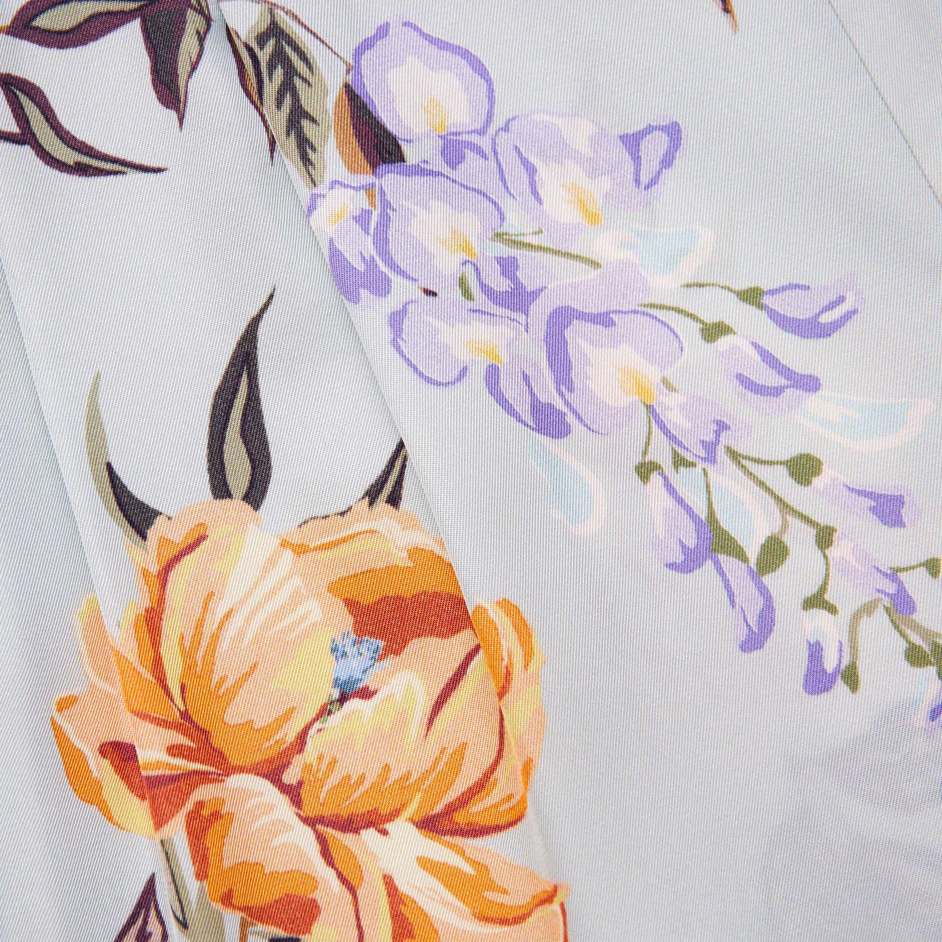 Side view of a woman wearing the Blue Floral Viscose Trousers