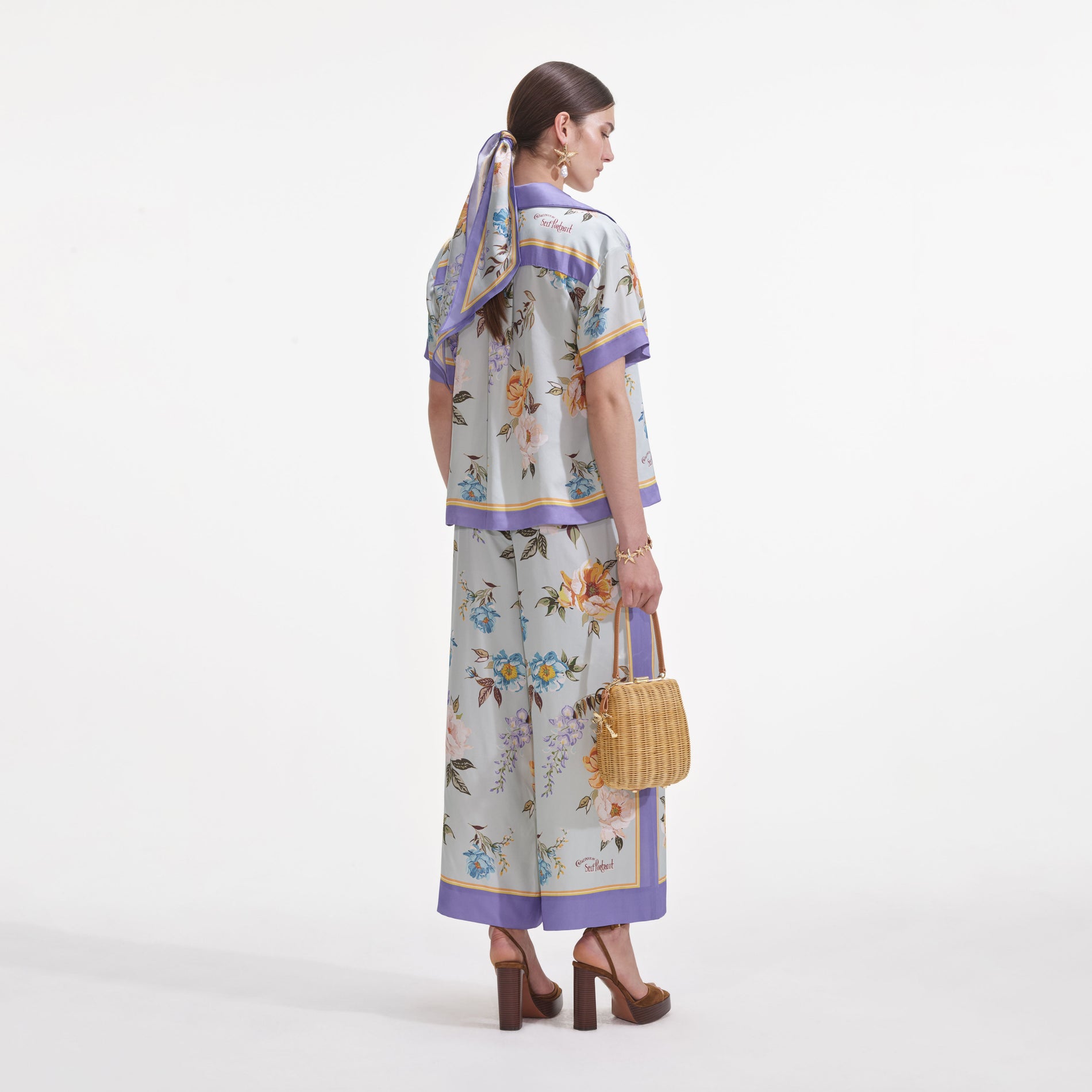 Back view of a woman wearing the Blue Floral Viscose Shirt