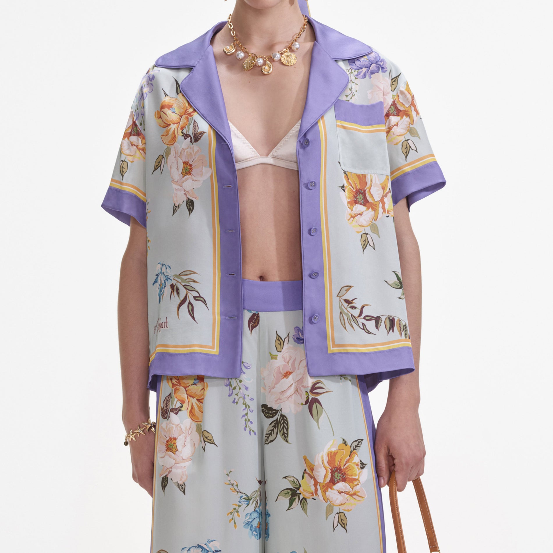 A close up of a woman wearing the Blue Floral Viscose Shirt