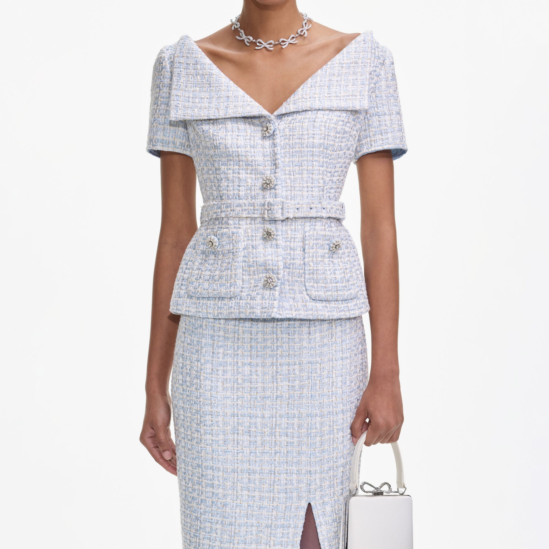 A close up of a woman wearing the Blue Boucle Midi Dress