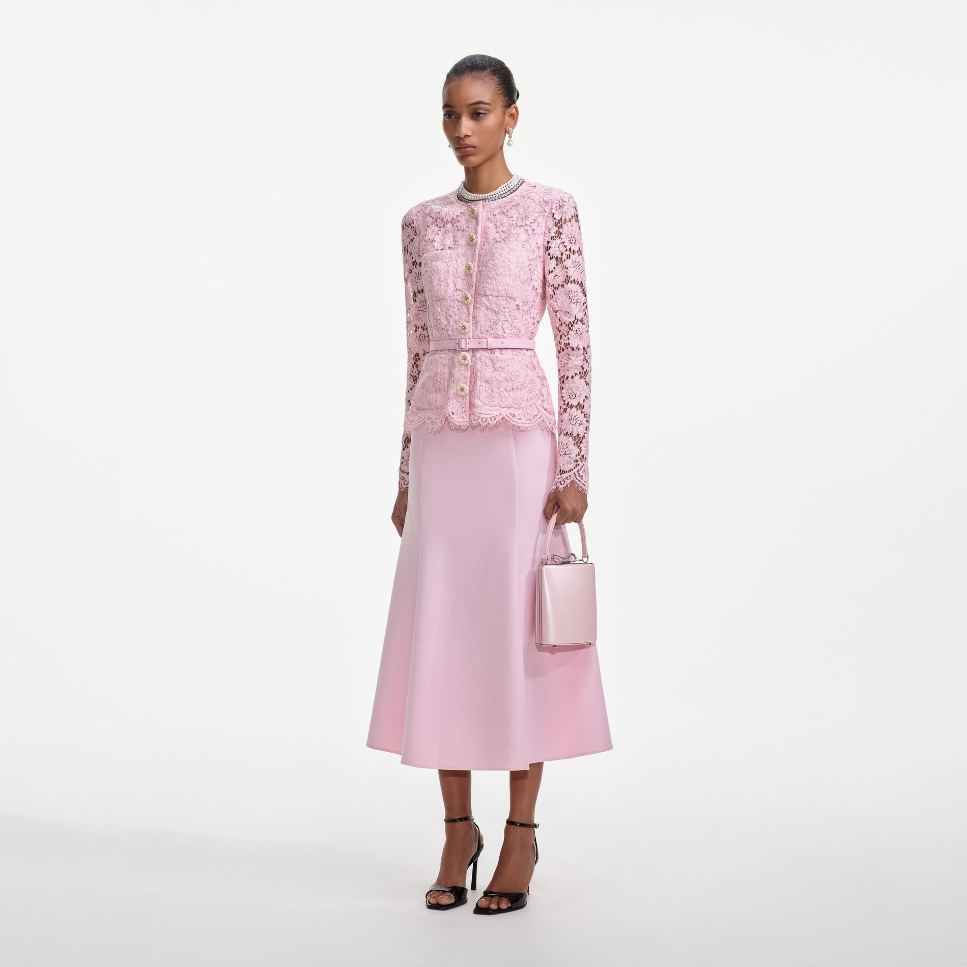 Side view of a woman wearing the Pink Tailored Lace Midi Dress